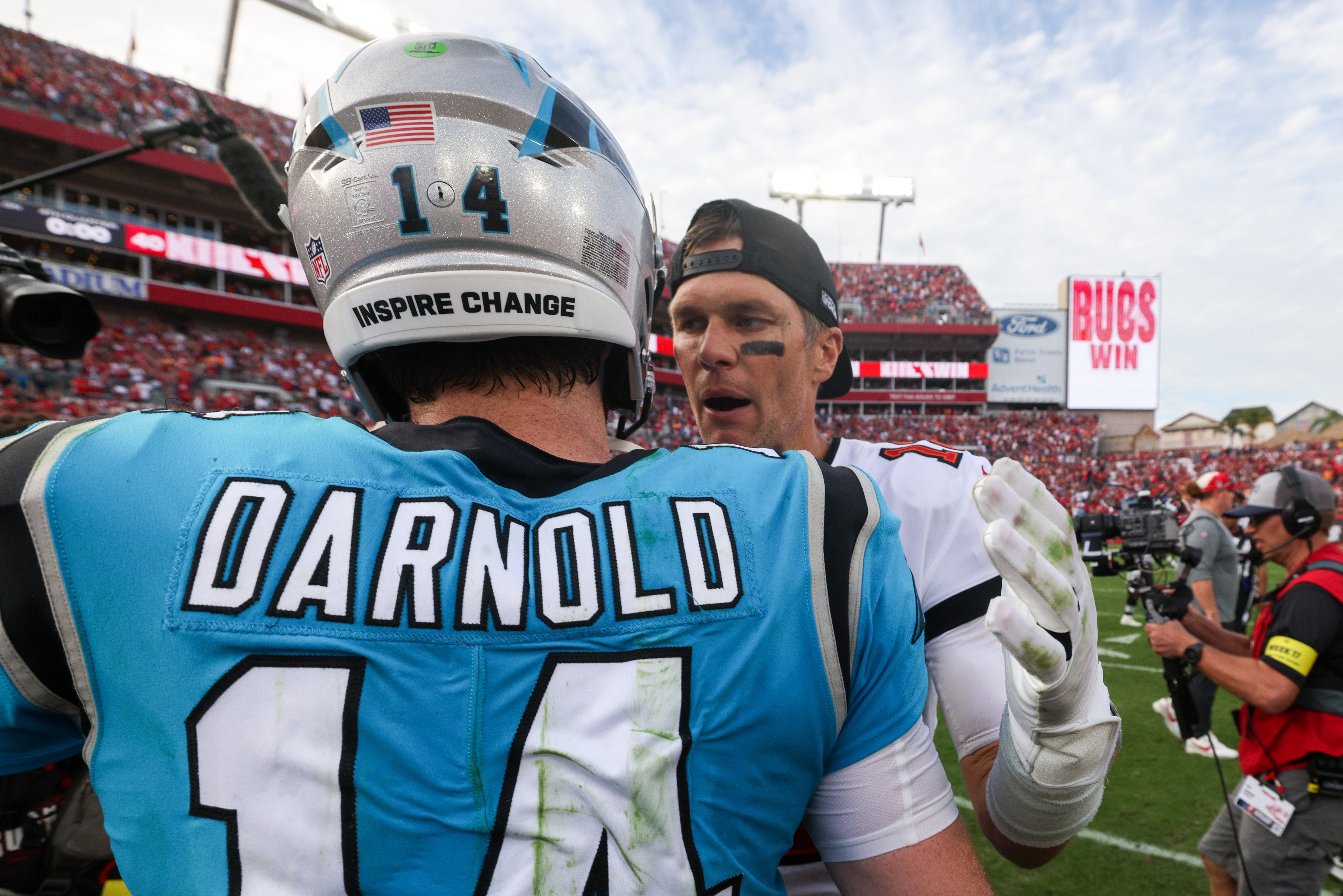 Jan 1, 2023; Tampa, Florida, USA; Tampa Bay Buccaneers quarterback Tom Brady (12) greets Carolina Panthers quarterback Sam Darnold (14) after a game at Raymond James Stadium.
