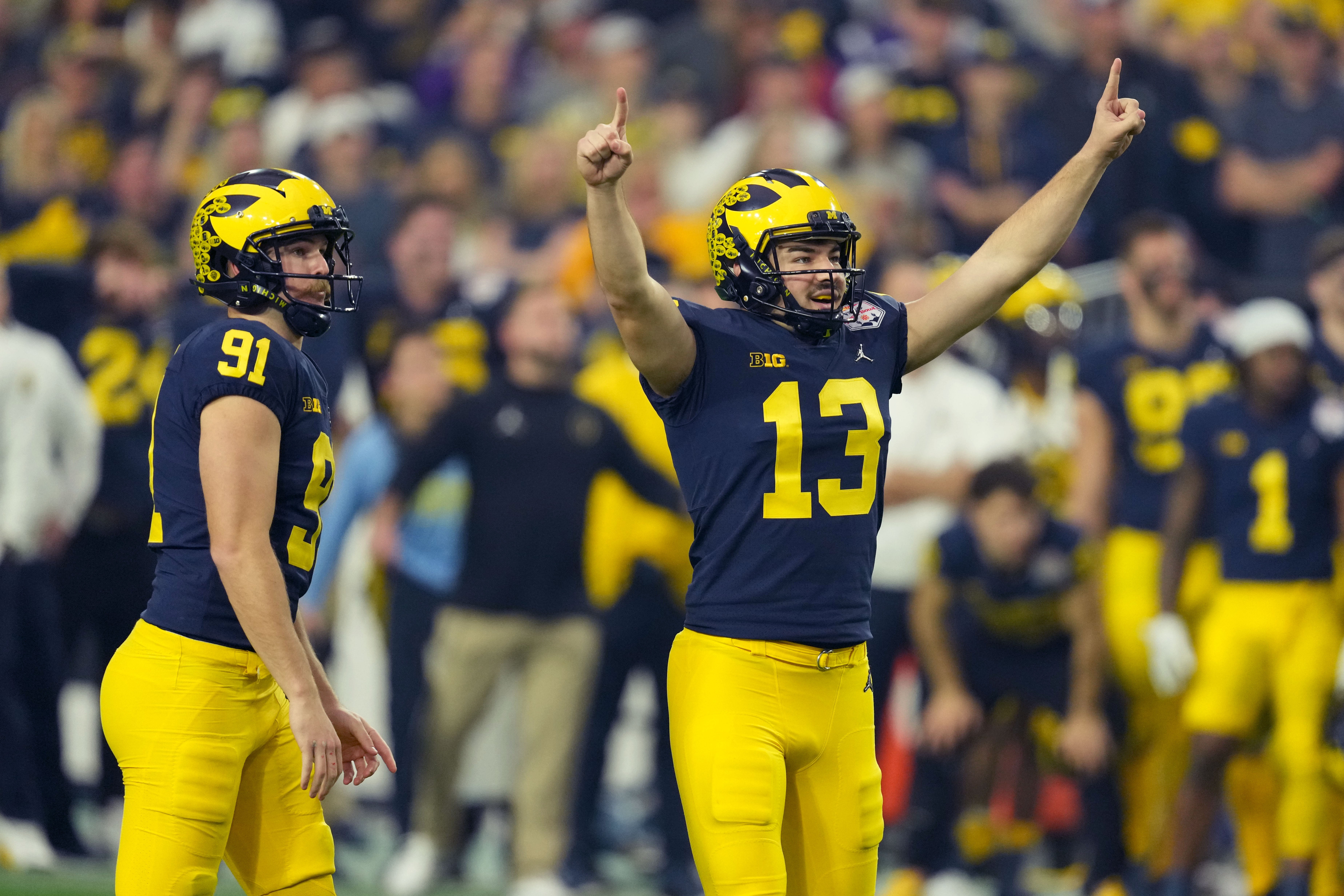 Dec 31, 2022; Glendale, Arizona, USA; Michigan Wolverines place kicker Jake Moody (13) celebrates his 59-yard field goal against the TCU Horned Frogs in the first half of the 2022 Fiesta Bowl at State Farm Stadium.