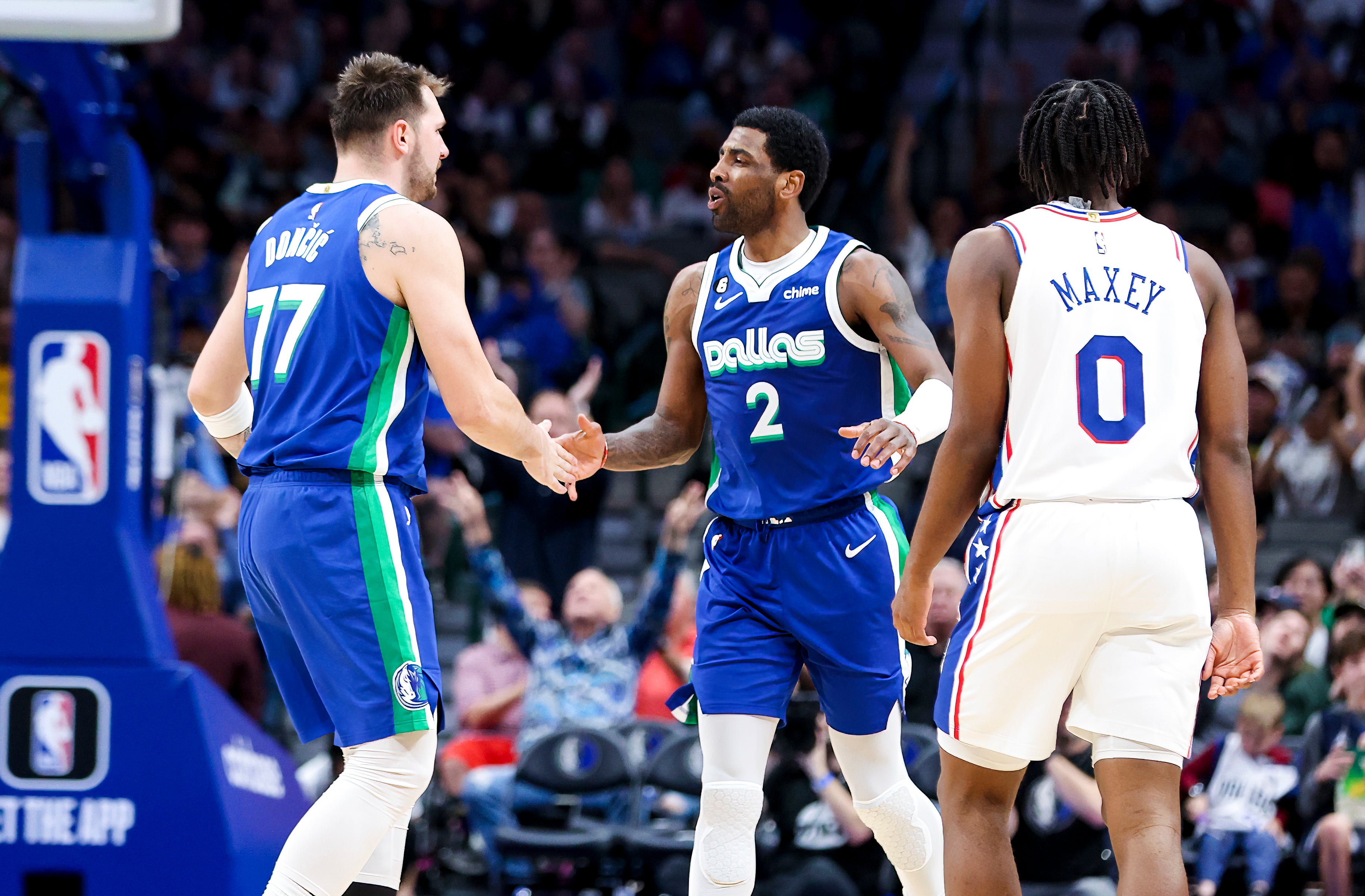 Mar 2, 2023; Dallas, Texas, USA; Dallas Mavericks guard Luka Doncic (77) celebrates with Dallas Mavericks guard Kyrie Irving (2) in front of Philadelphia 76ers guard Tyrese Maxey (0) during the second half at American Airlines Center.