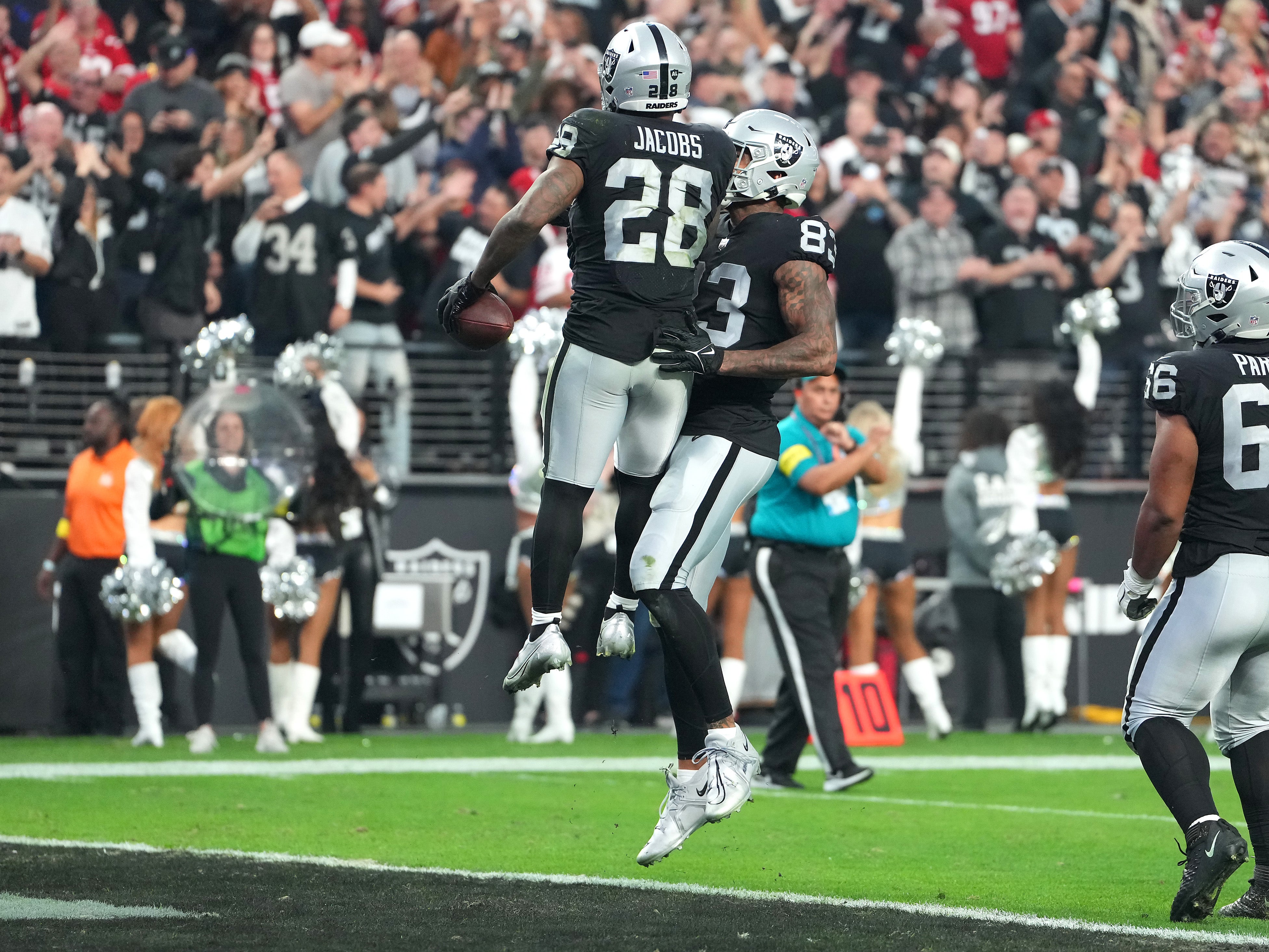 Jan 1, 2023; Paradise, Nevada, USA; Las Vegas Raiders running back Josh Jacobs (28) celebrates with Las Vegas Raiders tight end Darren Waller (83) after scoring a touchdown against the San Francisco 49ers during the second half at Allegiant Stadium.