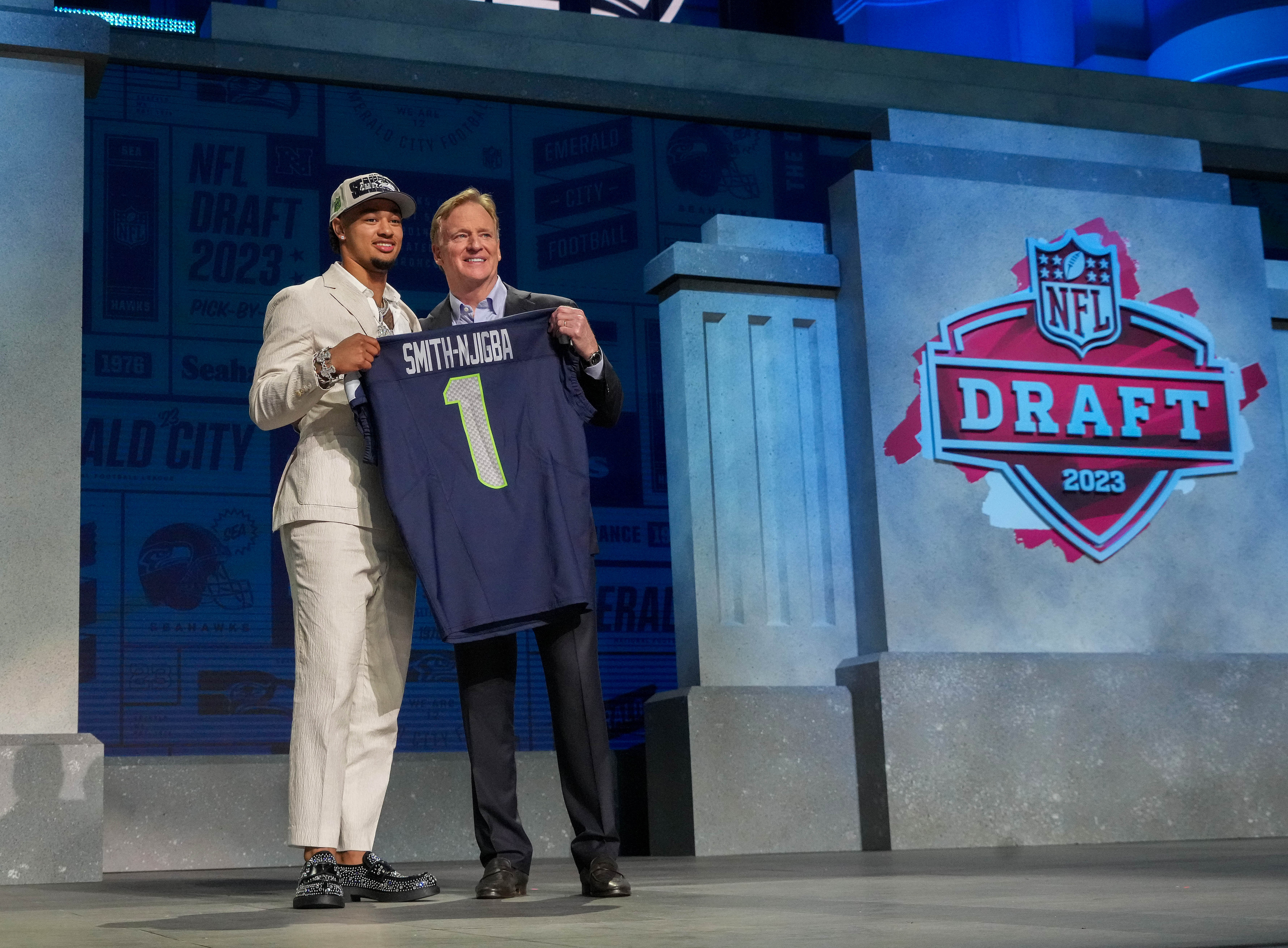 Apr 27, 2023; Kansas City, MO, USA; Ohio State wide receiver Jaxon Smith-Njigba with NFL commissioner Roger Goodell after being selected by the Seattle Seahawks twentieth overall in the first round of the 2023 NFL Draft at Union Station.