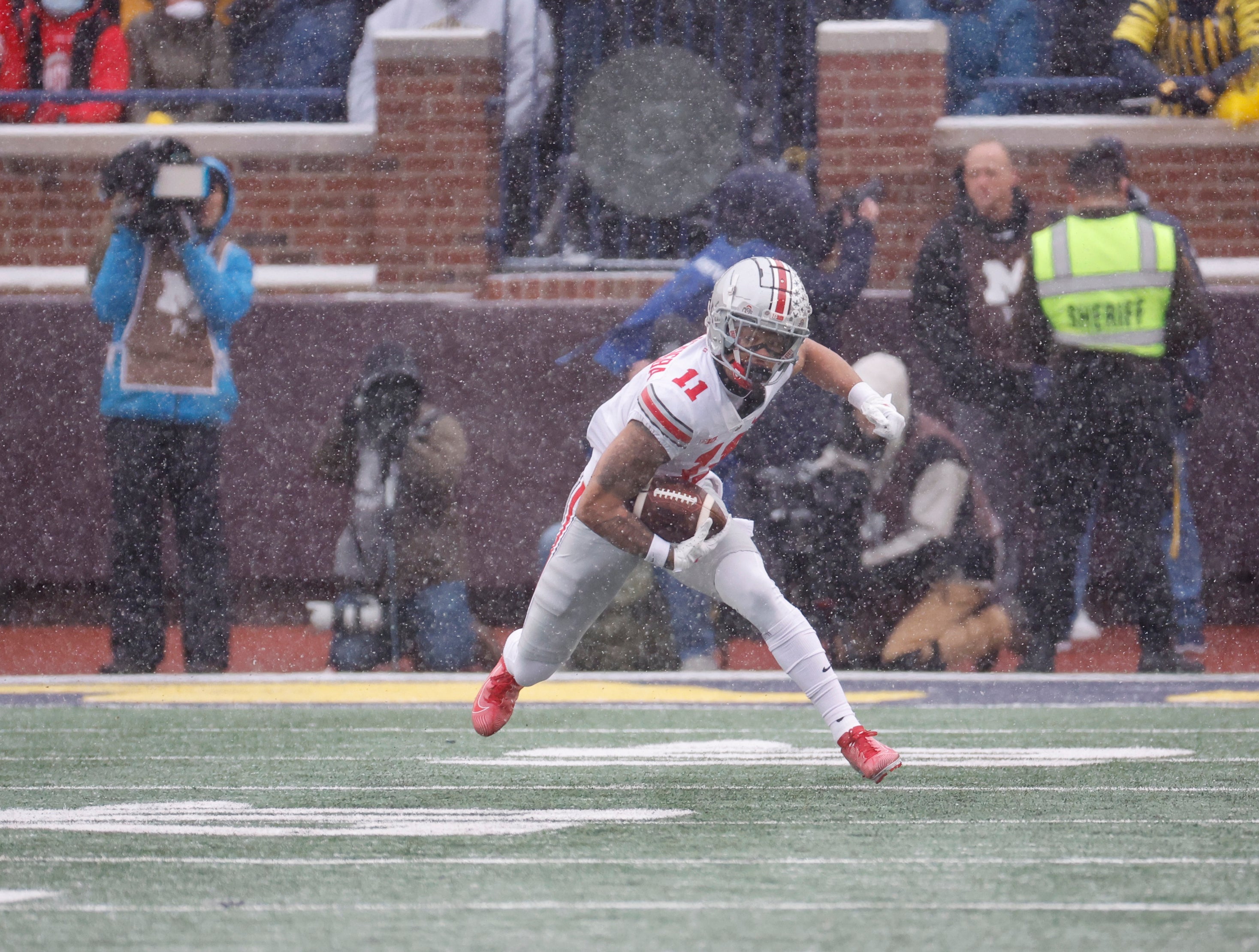 Nov 27, 2021; Ann Arbor, Michigan, USA; Ohio State Buckeyes wide receiver Jaxon Smith-Njigba (11) rush the ball in the first half against the Michigan Wolverines at Michigan Stadium.