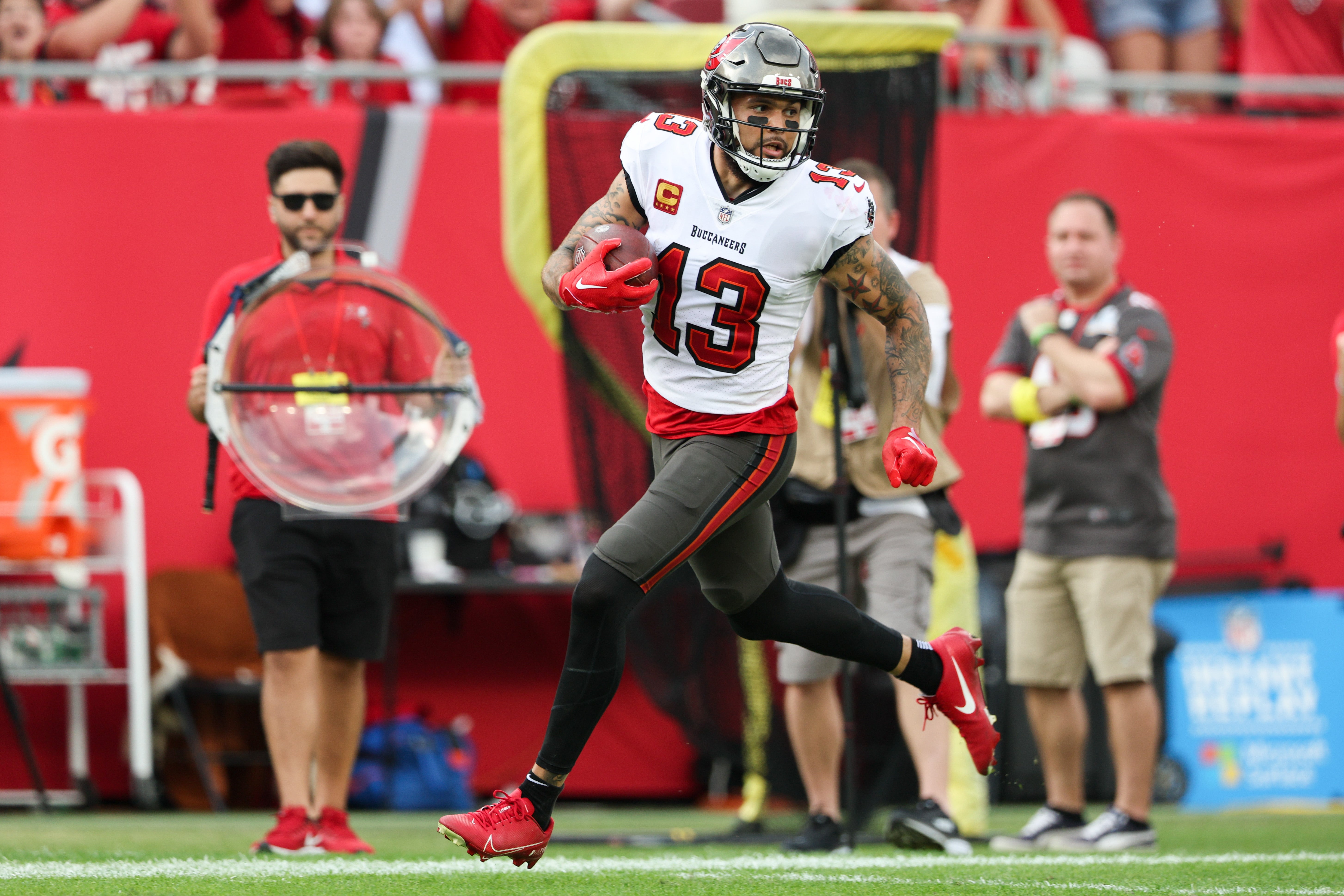 Jan 1, 2023; Tampa, Florida, USA; Tampa Bay Buccaneers wide receiver Mike Evans (13) catches a pass from touchdown against the Carolina Panthers in the second quarter at Raymond James Stadium. Mandatory Credit: Nathan Ray Seebeck-USA TODAY Sports