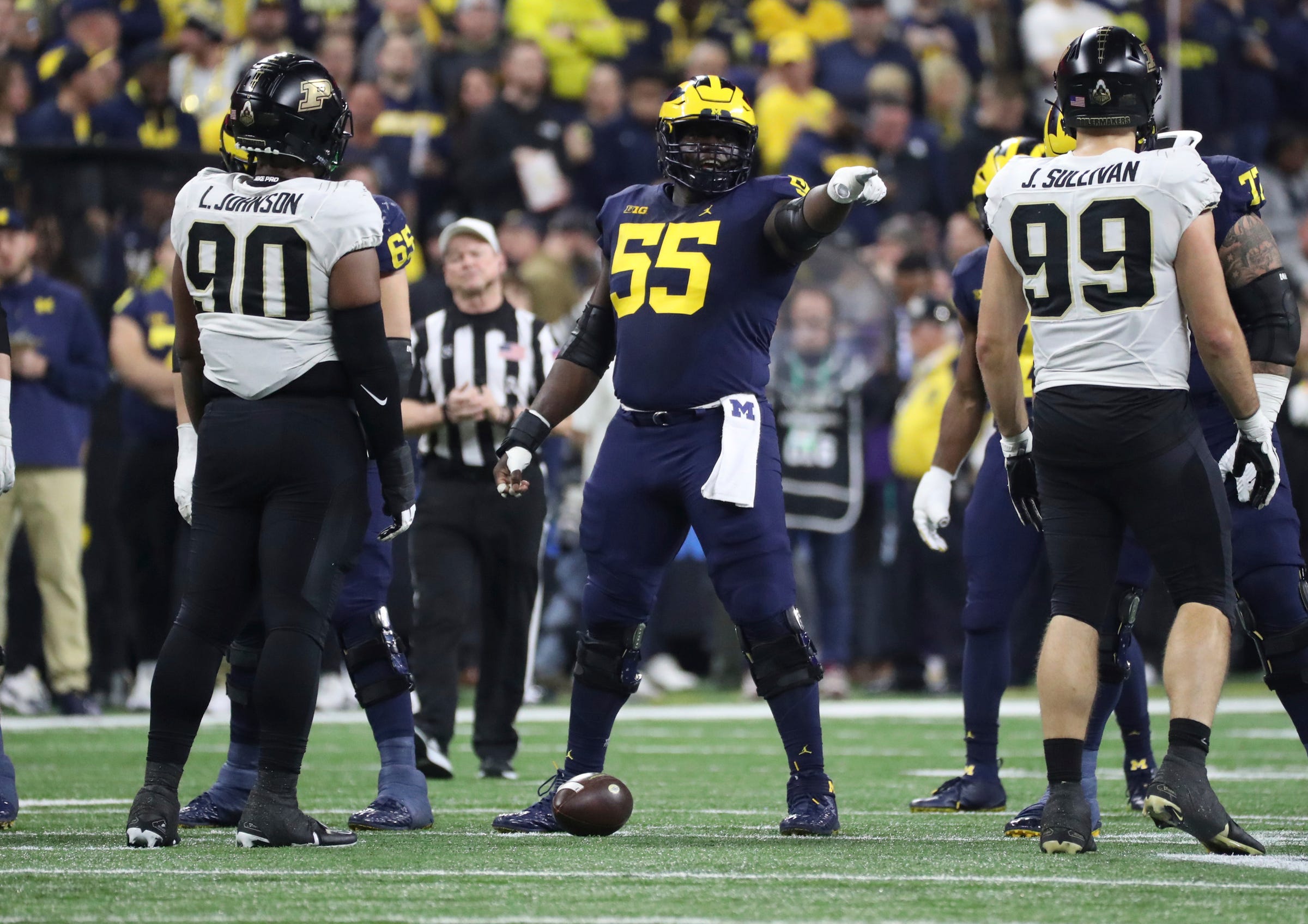 Michigan Wolverines offensive lineman Olusegun Oluwatimi (55) lines up against the Purdue Boilermakers during the first half of the Big Ten championship game at Lucas Oil Stadium in Indianapolis, Saturday, Dec. 3, 2022.