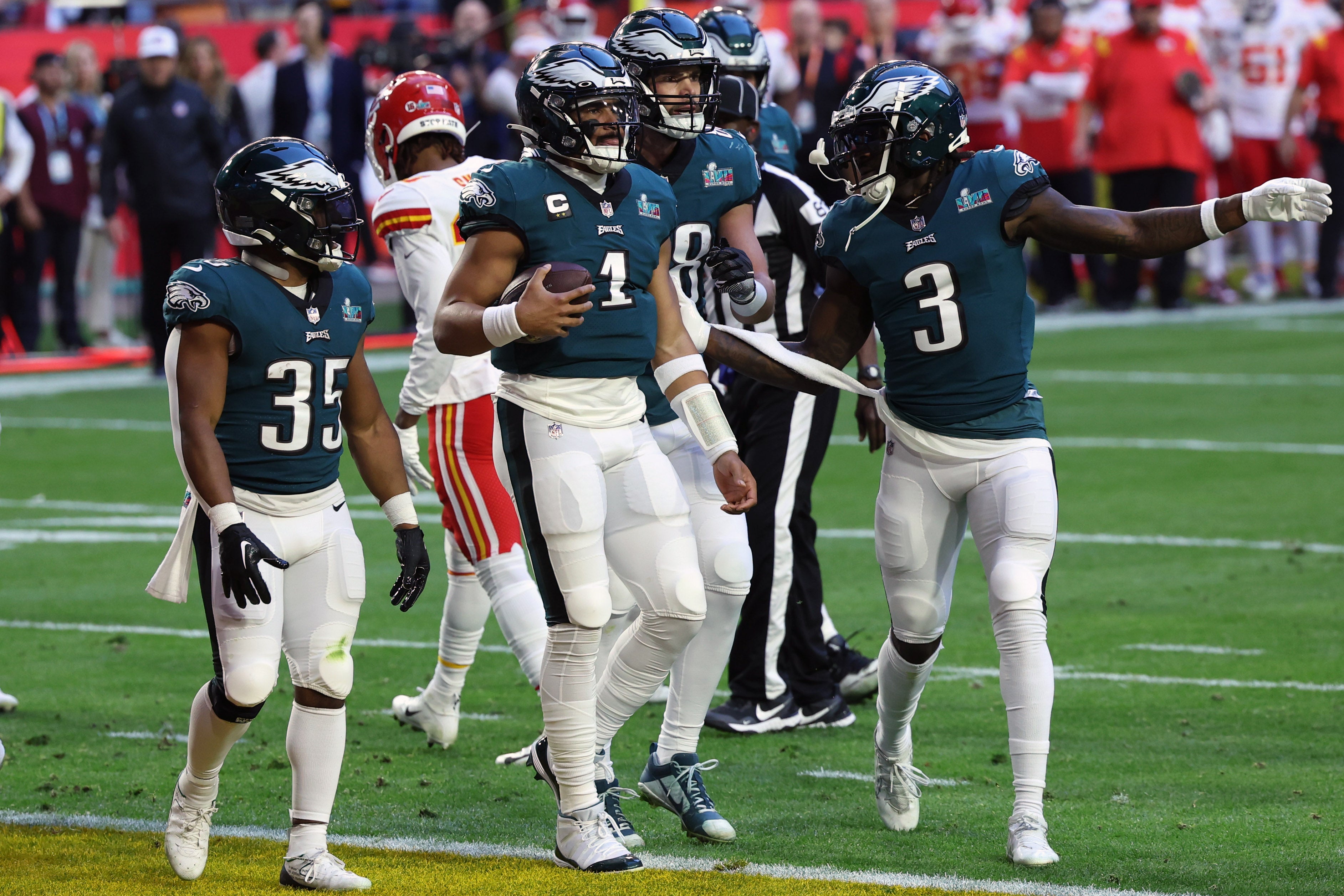 Feb 12, 2023; Glendale, Arizona, US; Philadelphia Eagles quarterback Jalen Hurts (1) celebrates with running back Boston Scott (35) and wide receiver Zach Pascal (3) after scoring a touchdown against the Kansas City Chiefs in the first quarter of Super Bowl LVII at State Farm Stadium. Mandatory Credit: Bill Streicher-USA TODAY Sports