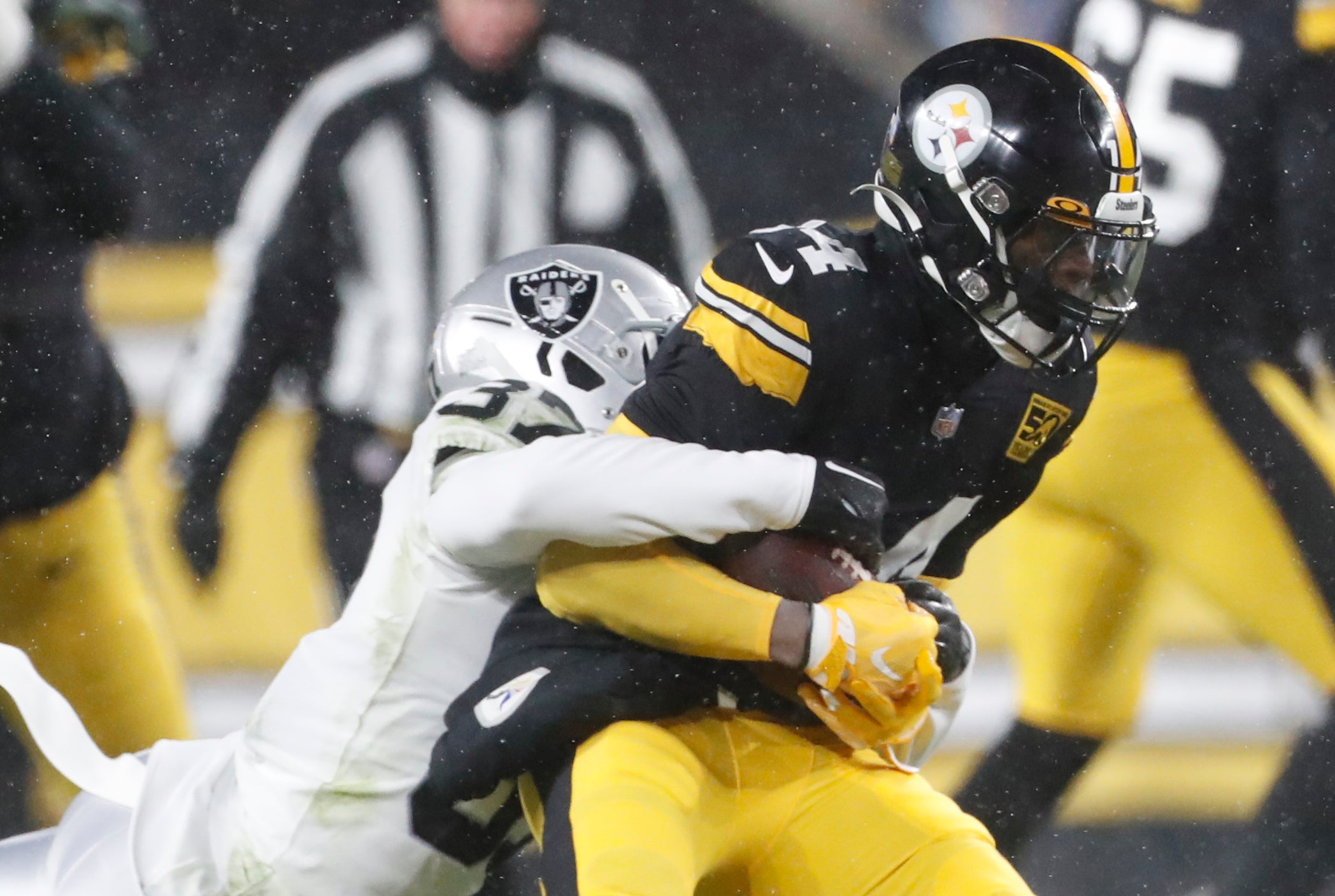 Dec 24, 2022; Pittsburgh, Pennsylvania, USA; Pittsburgh Steelers wide receiver George Pickens (14) runs after a catch against Las Vegas Raiders cornerback Tyler Hall (37) during the second quarter at Acrisure Stadium.