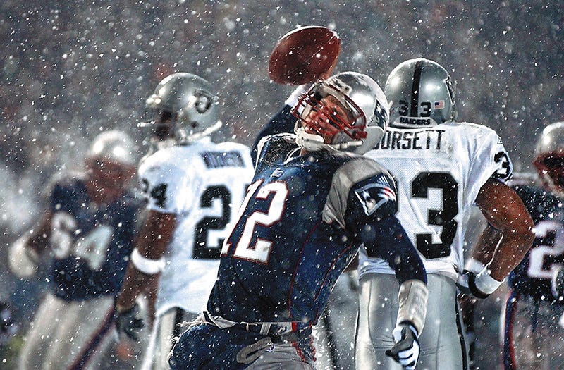 Tom Brady spikes the ball after scoring fourth-quarter touchdown in the famous \"tuck rule\" game against the Raiders in January 2002. Twenty years later, Brady has officially retired from the NFL. CP 2