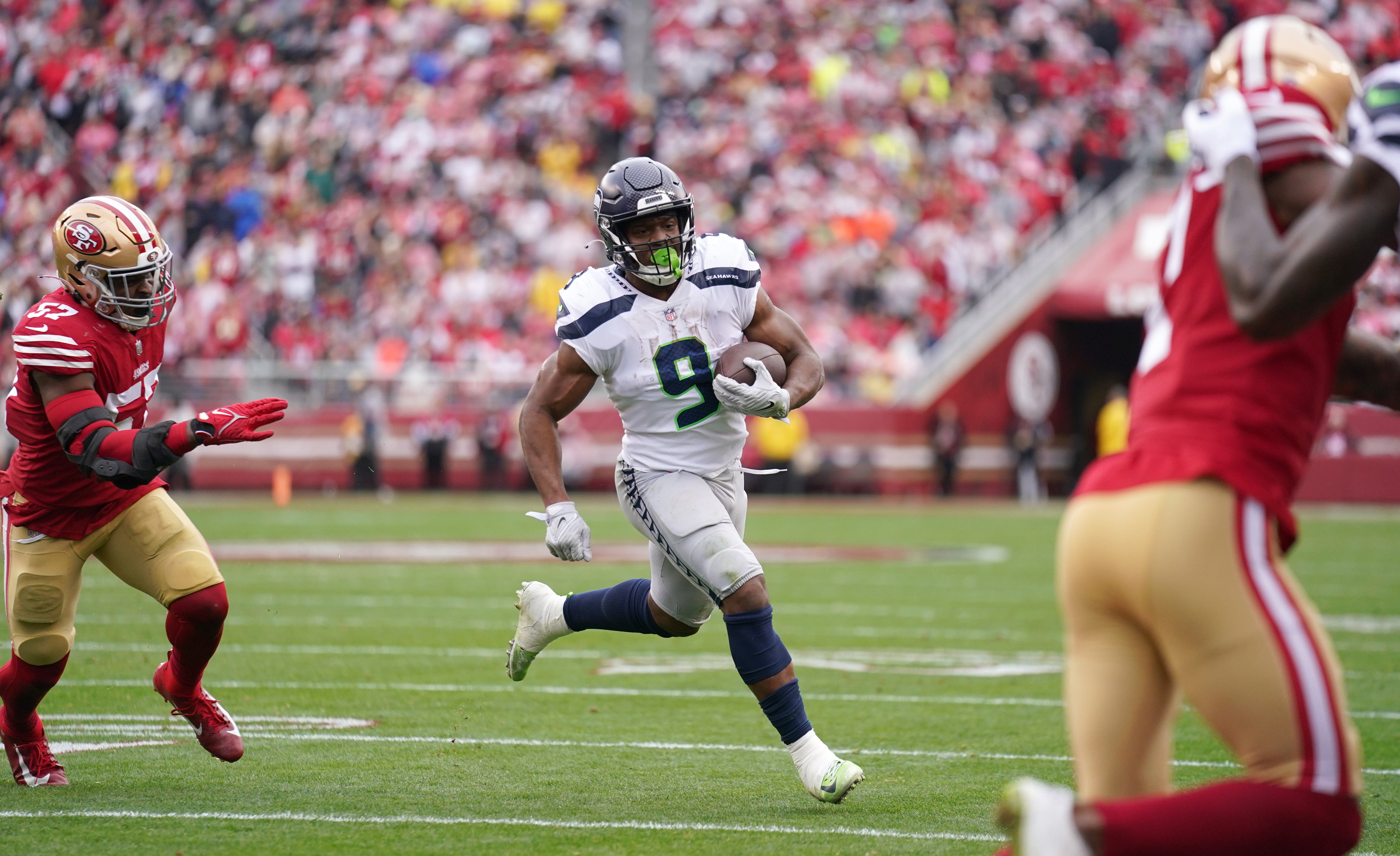 Jan 14, 2023; Santa Clara, California, USA; Seattle Seahawks running back Kenneth Walker III (9) runs away from San Francisco 49ers linebacker Dre Greenlaw (57) for a second quarter touchdown run during a wild card game at Levi's Stadium.