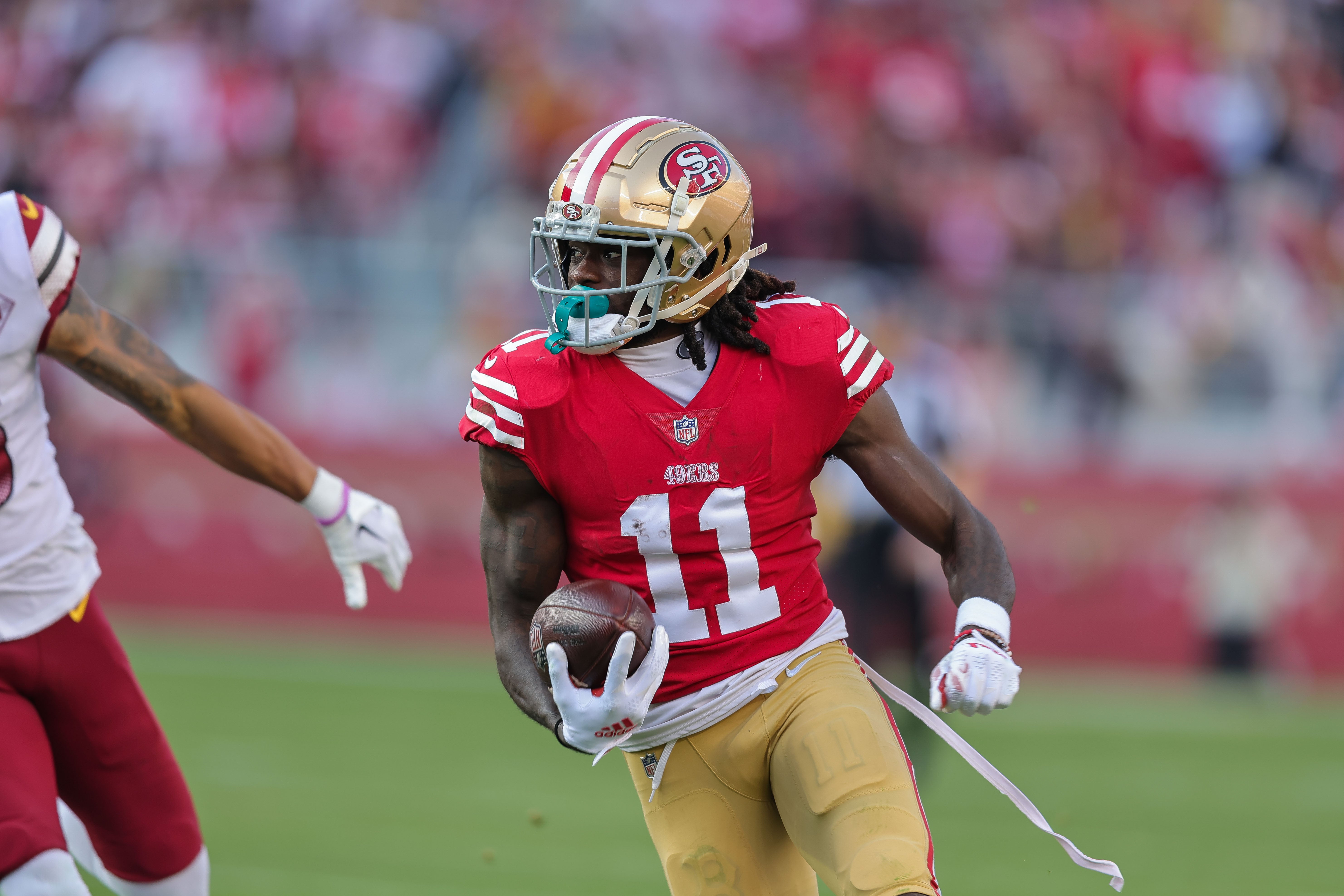 Dec 24, 2022; Santa Clara, California, USA; San Francisco 49ers wide receiver Brandon Aiyuk (11) runs with the ball during the third quarter against the Washington Commanders at Levi's Stadium.