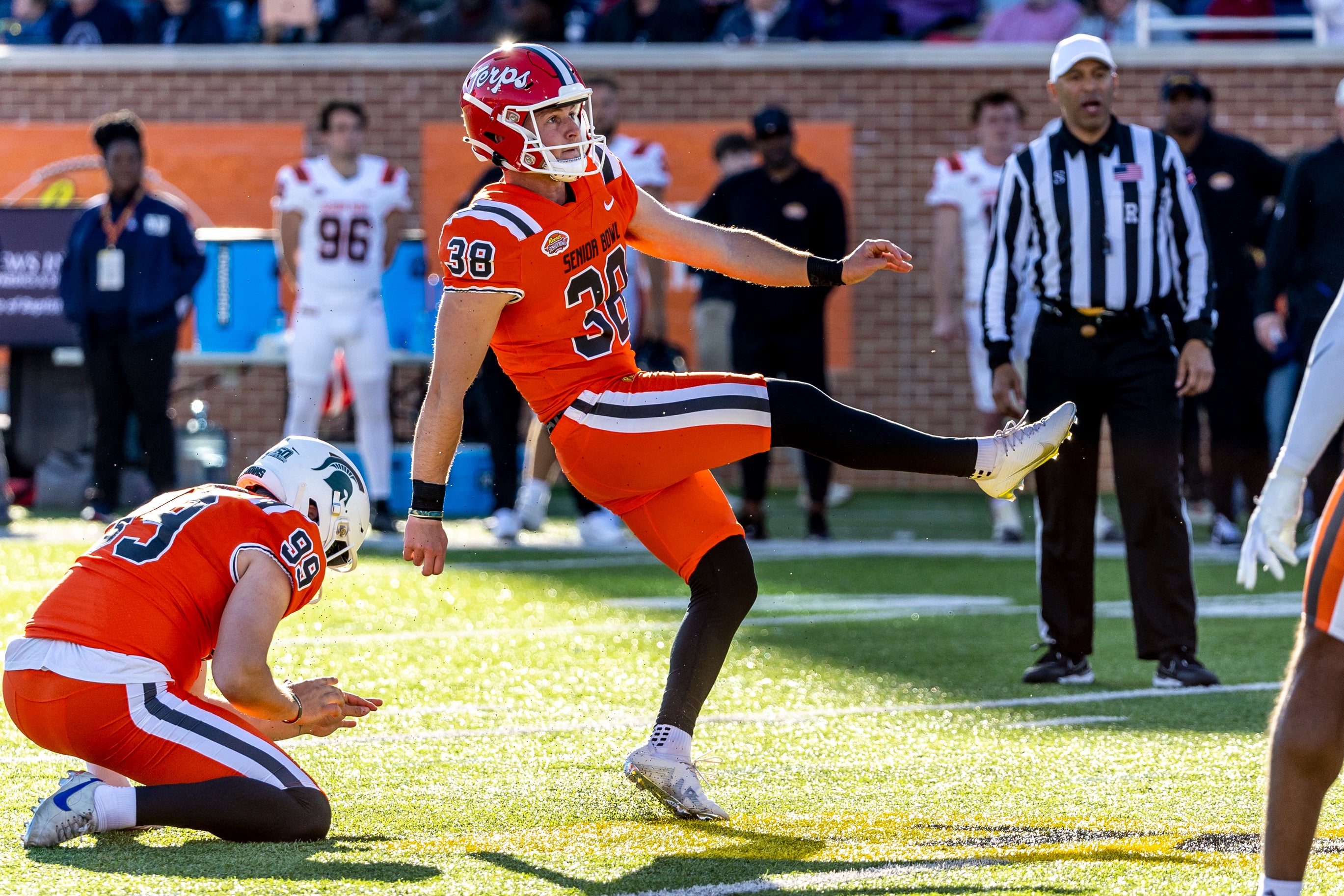 National kicker Chad Ryland of Maryland (38) tries a field goal attempt from the hold of punter Bryce Baringer of Michigan State (99) against the American squad during the second half of the Senior Bowl.