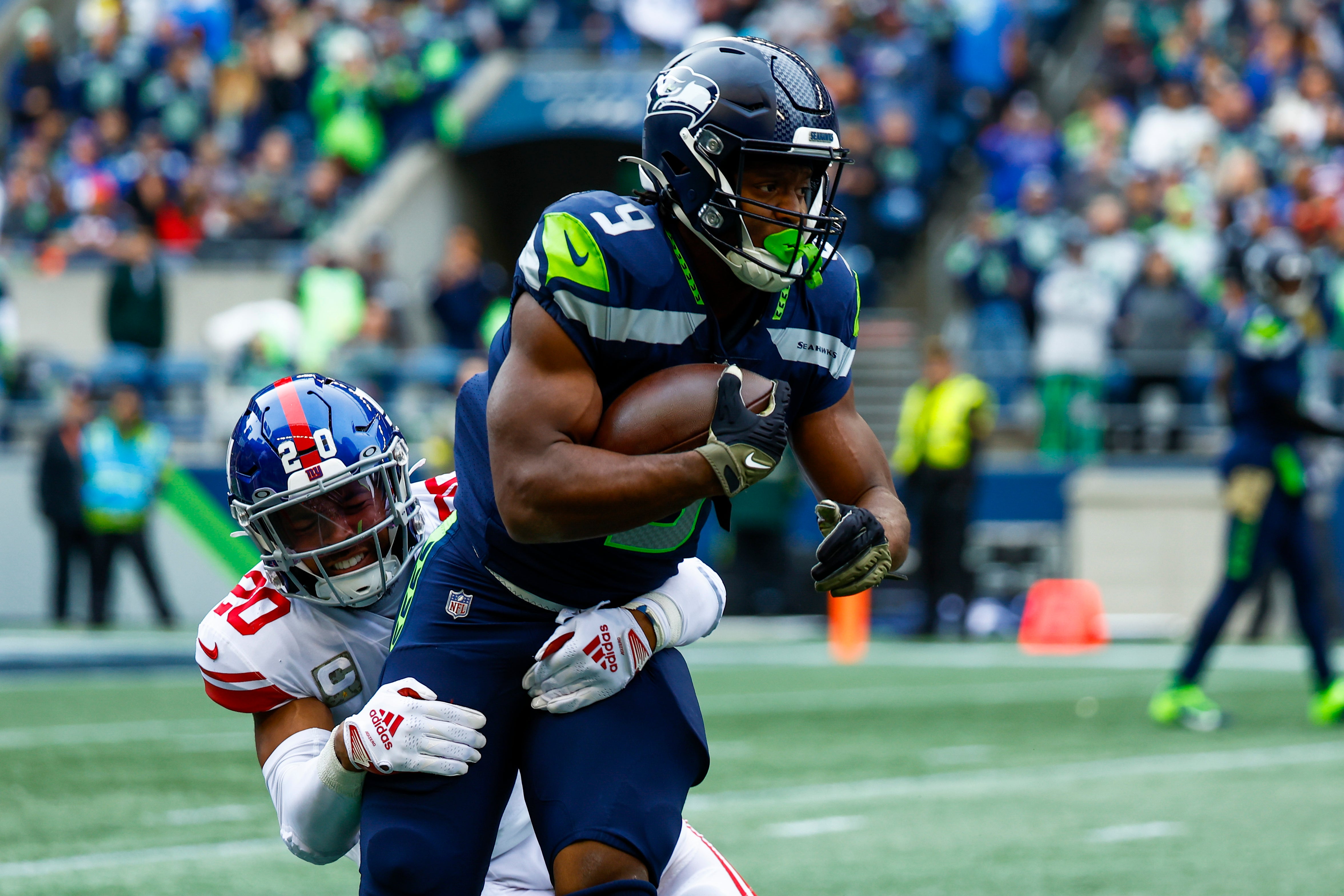 Oct 30, 2022; Seattle, Washington, USA; New York Giants safety Julian Love (20) tackles Seattle Seahawks running back Kenneth Walker III (9) on a rushing attempt during the first quarter at Lumen Field.
