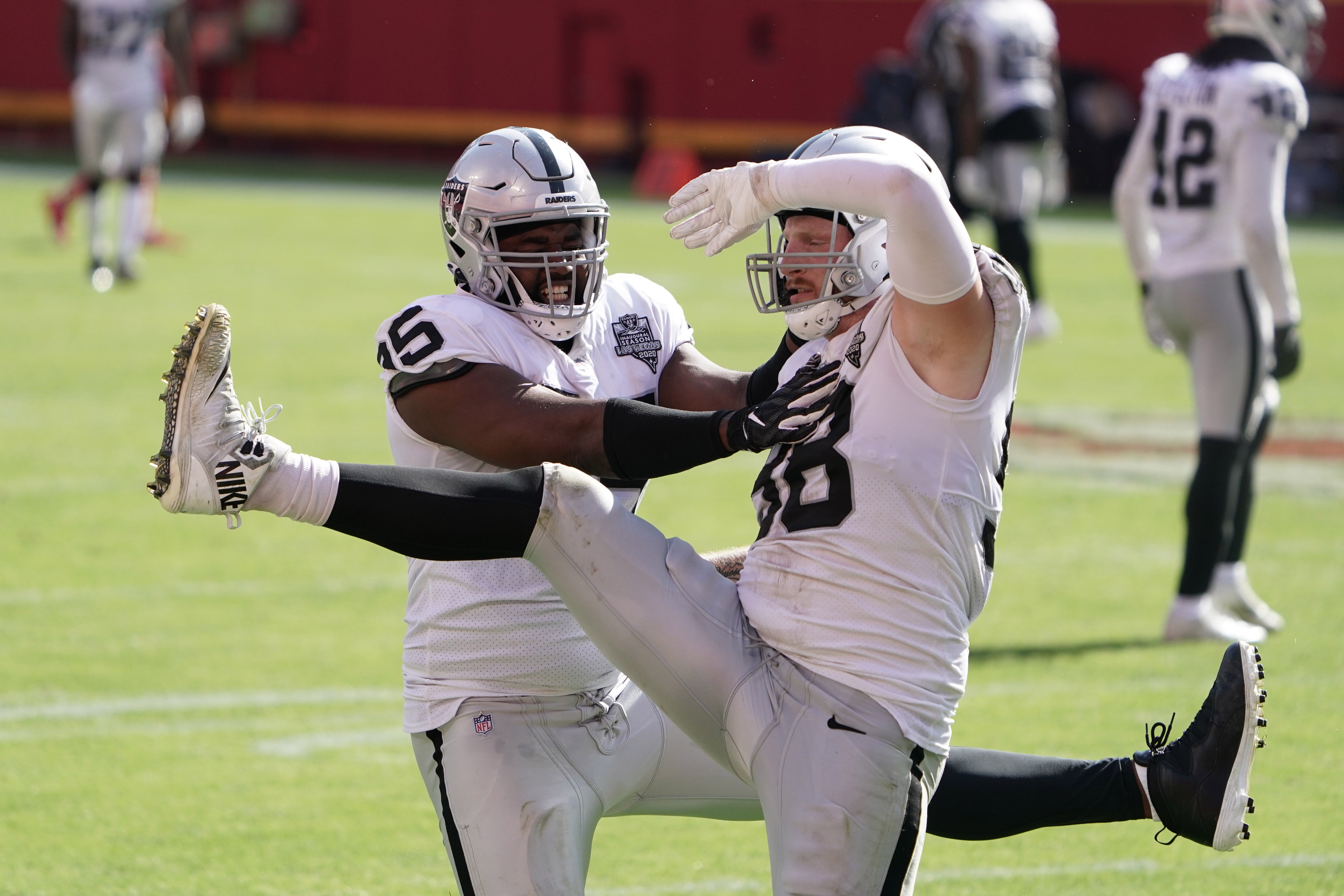 Oct 11, 2020; Kansas City, Missouri, USA; Las Vegas Raiders defensive end Maxx Crosby (98) and defensive end Datone Jones (95) celebrate after a sack in the fourth quarter against the Kansas City Chiefs at Arrowhead Stadium. The Raiders defeated the Chiefs 40-32.