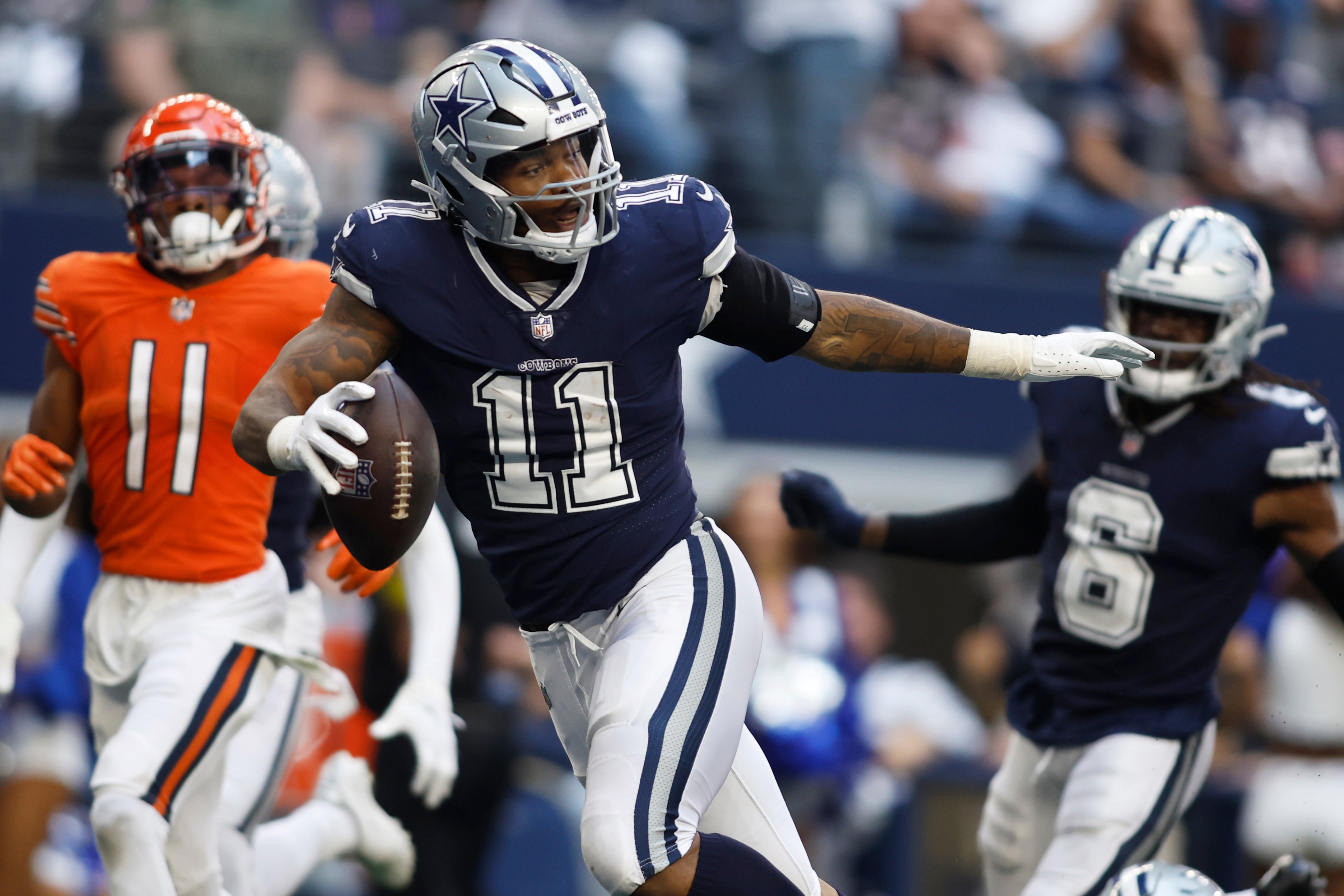 Dallas Cowboys pass rusher Micah Parsons returning a fumble recovery for a defensive touchdown against the Chicago Bears.