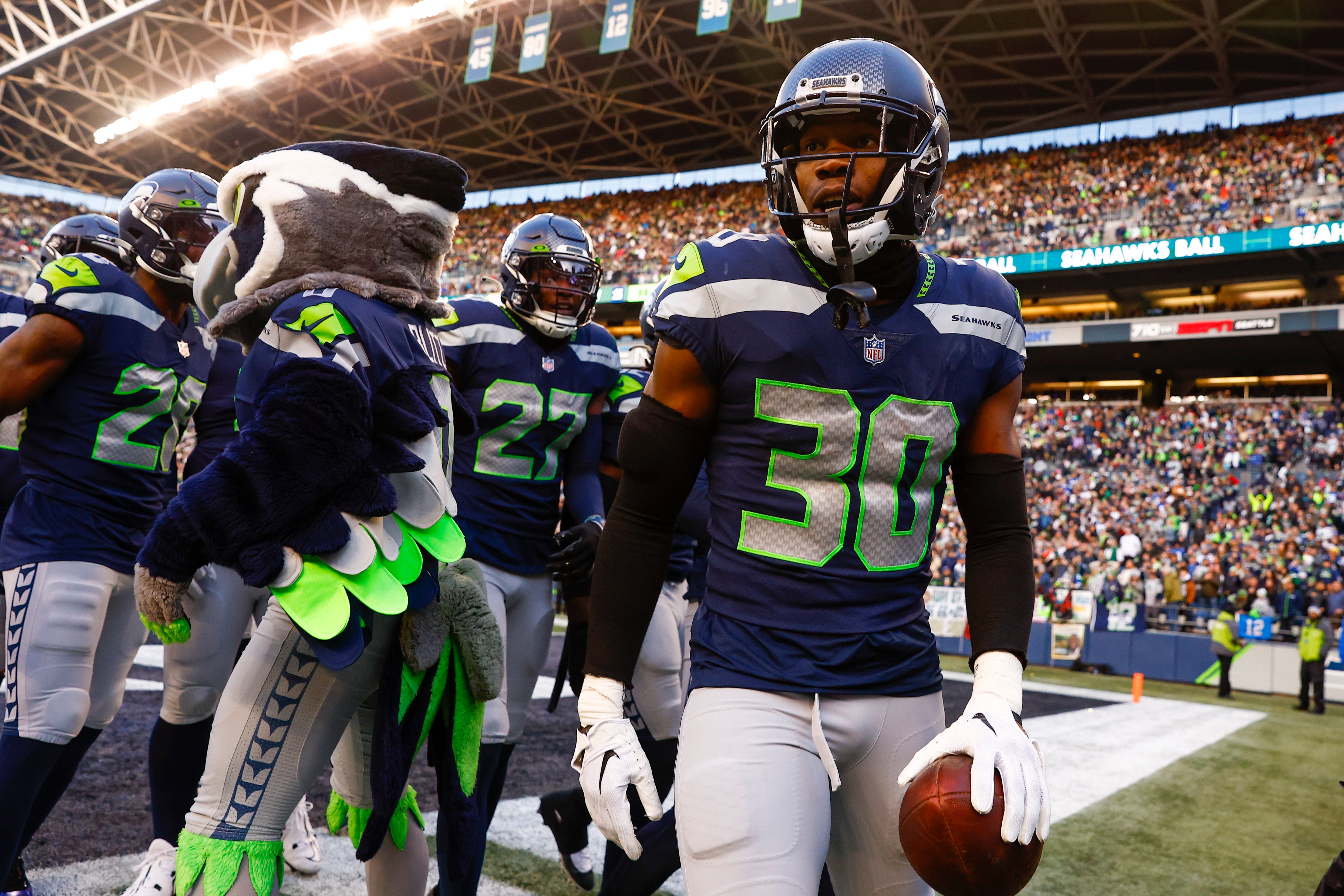 Jan 1, 2023; Seattle, Washington, USA; Seattle Seahawks cornerback Mike Jackson (30) returns to the bench following an interception against the New York Jets during the fourth quarter at Lumen Field.