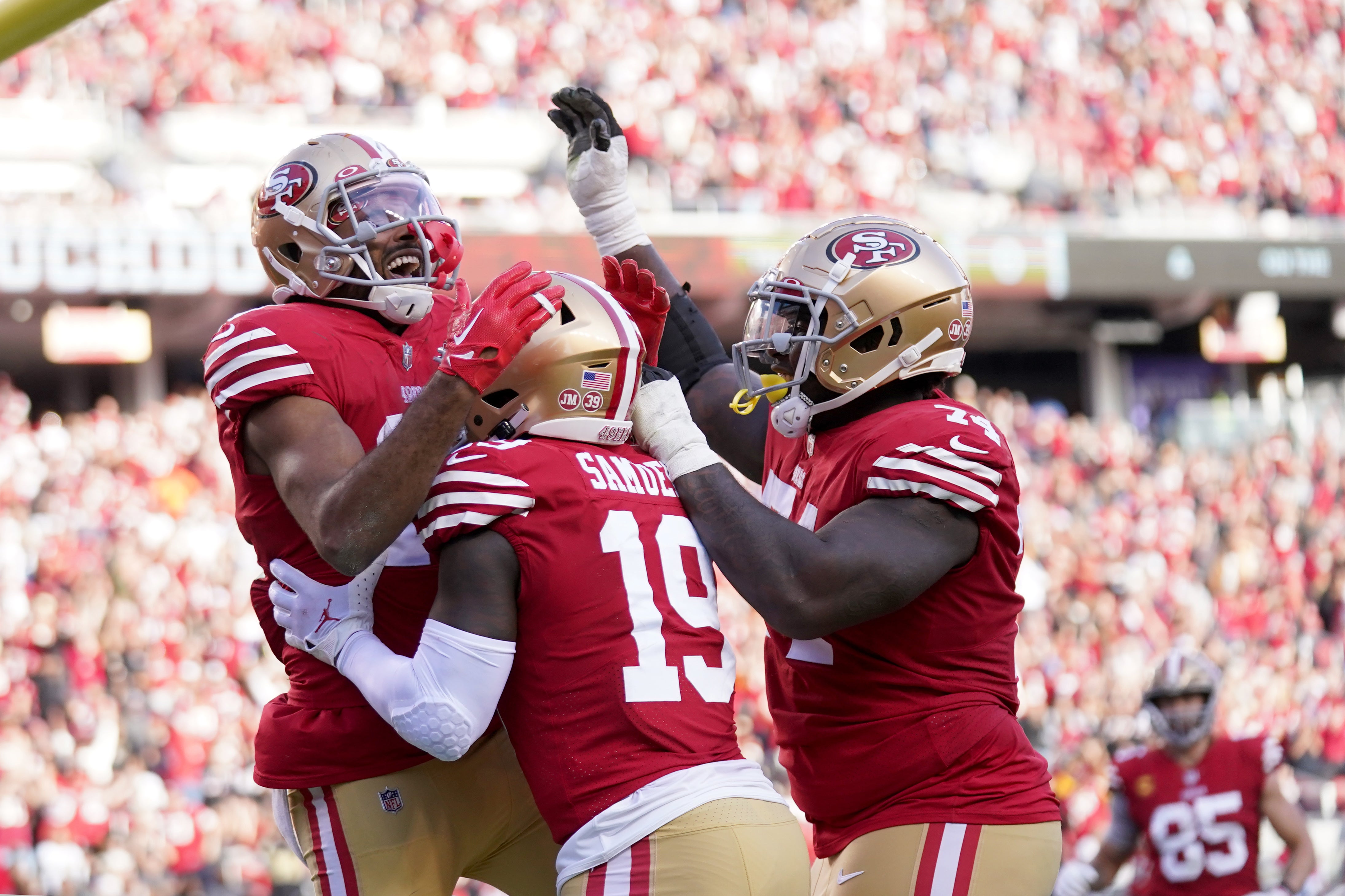 Nov 27, 2022; Santa Clara, California, USA; San Francisco 49ers wide receiver Jauan Jennings, left, celebrates with wide receiver Deebo Samuel (19) and offensive tackle Spencer Burford (74) after catching a touchdown pass against the New Orleans Saints in the second quarter at Levi's Stadium.