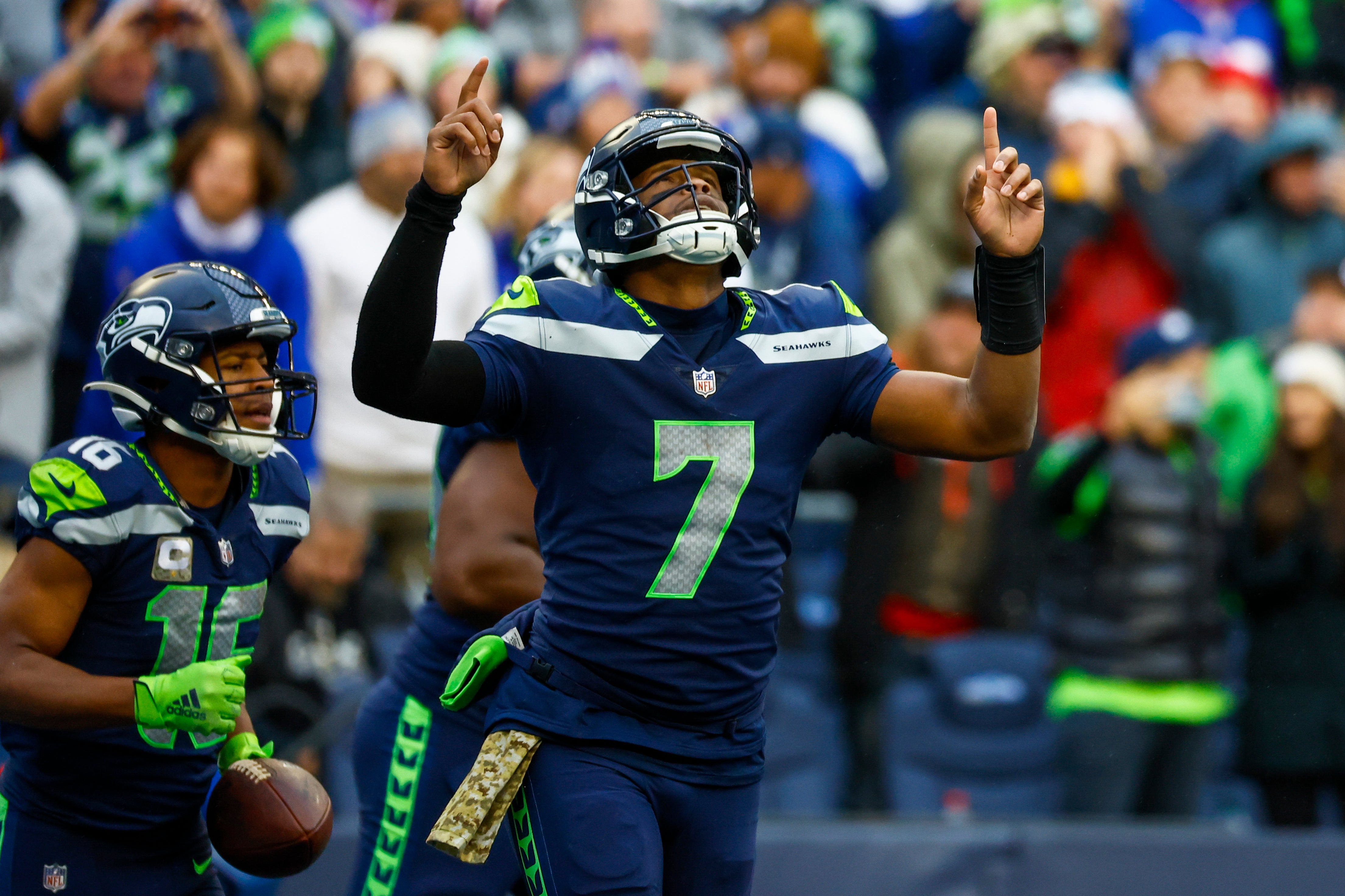 Oct 30, 2022; Seattle, Washington, USA; Seattle Seahawks quarterback Geno Smith (7) celebrates after throwing a touchdown pass to wide receiver Tyler Lockett (16) during the fourth quarter against the New York Giants at Lumen Field.