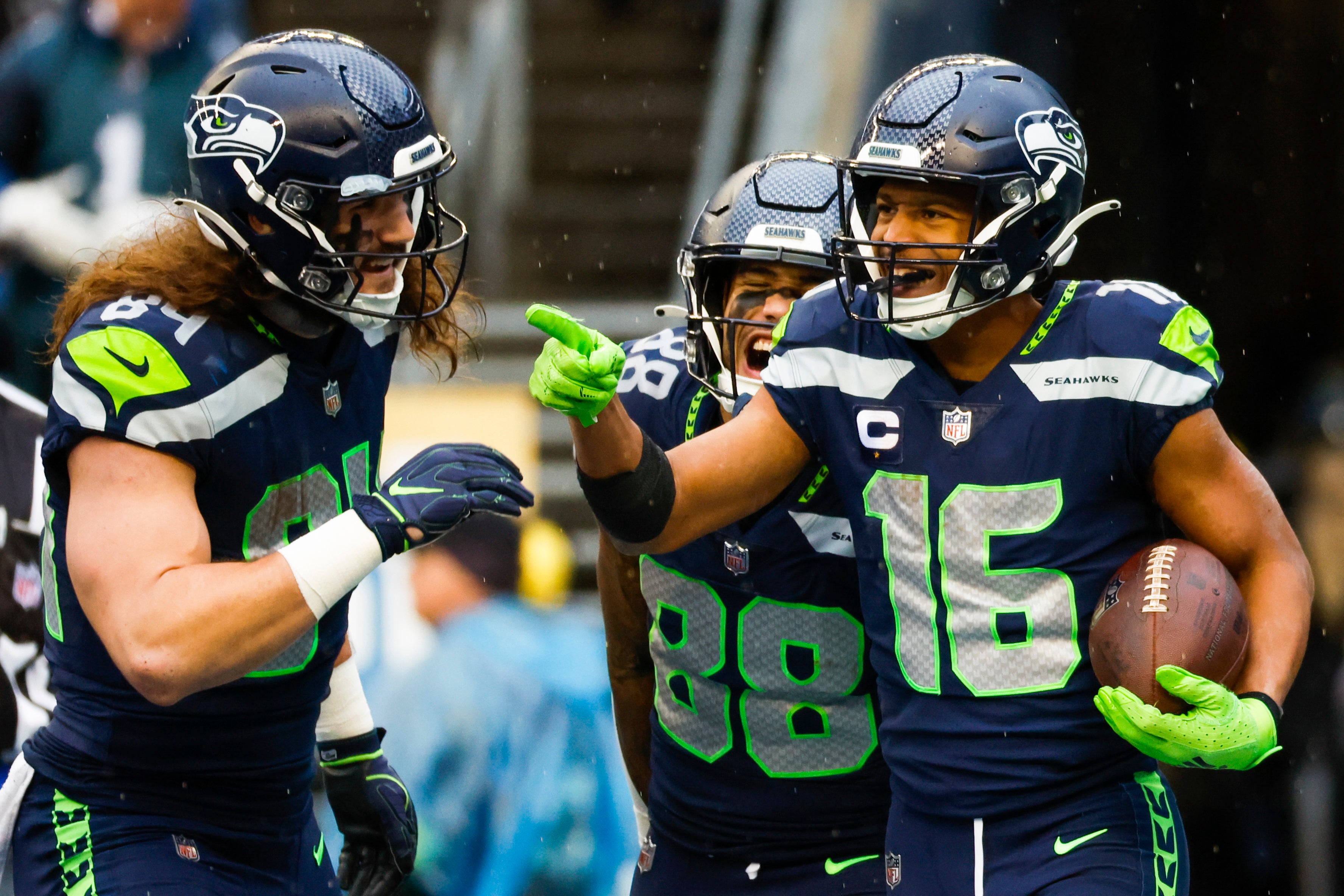 Jan 8, 2023; Seattle, Washington, USA; Seattle Seahawks wide receiver Tyler Lockett (16) celebrates with tight end Colby Parkinson (84) and wide receiver Cade Johnson (88) after catching a touchdown pass against the Los Angeles Rams during the third quarter at Lumen Field.