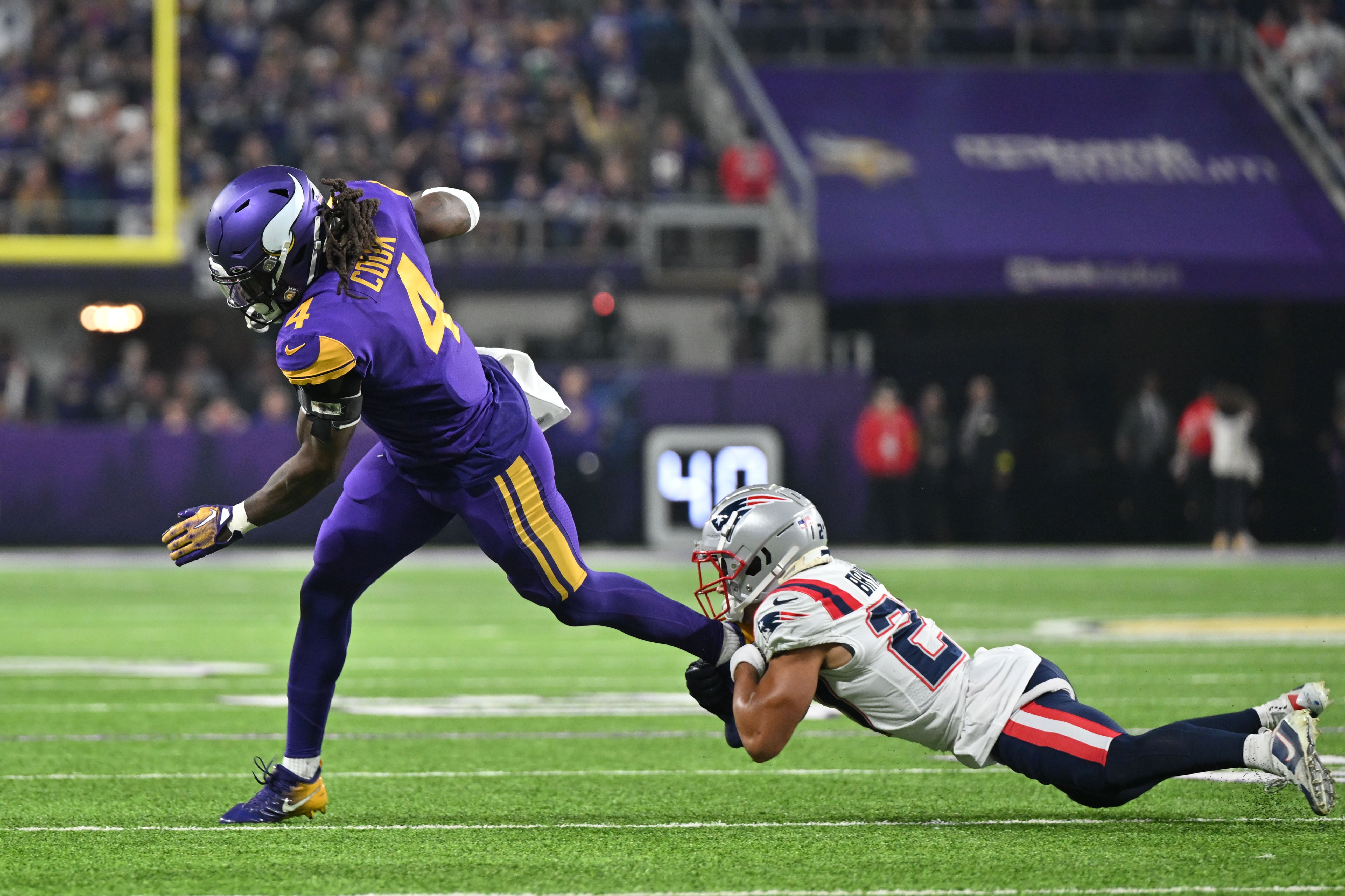 Nov 20, 2022; Minneapolis, Minnesota, USA; Minnesota Vikings running back Dalvin Cook (4) and New England Patriots cornerback Myles Bryant (27) in action during the game at U.S. Bank Stadium.