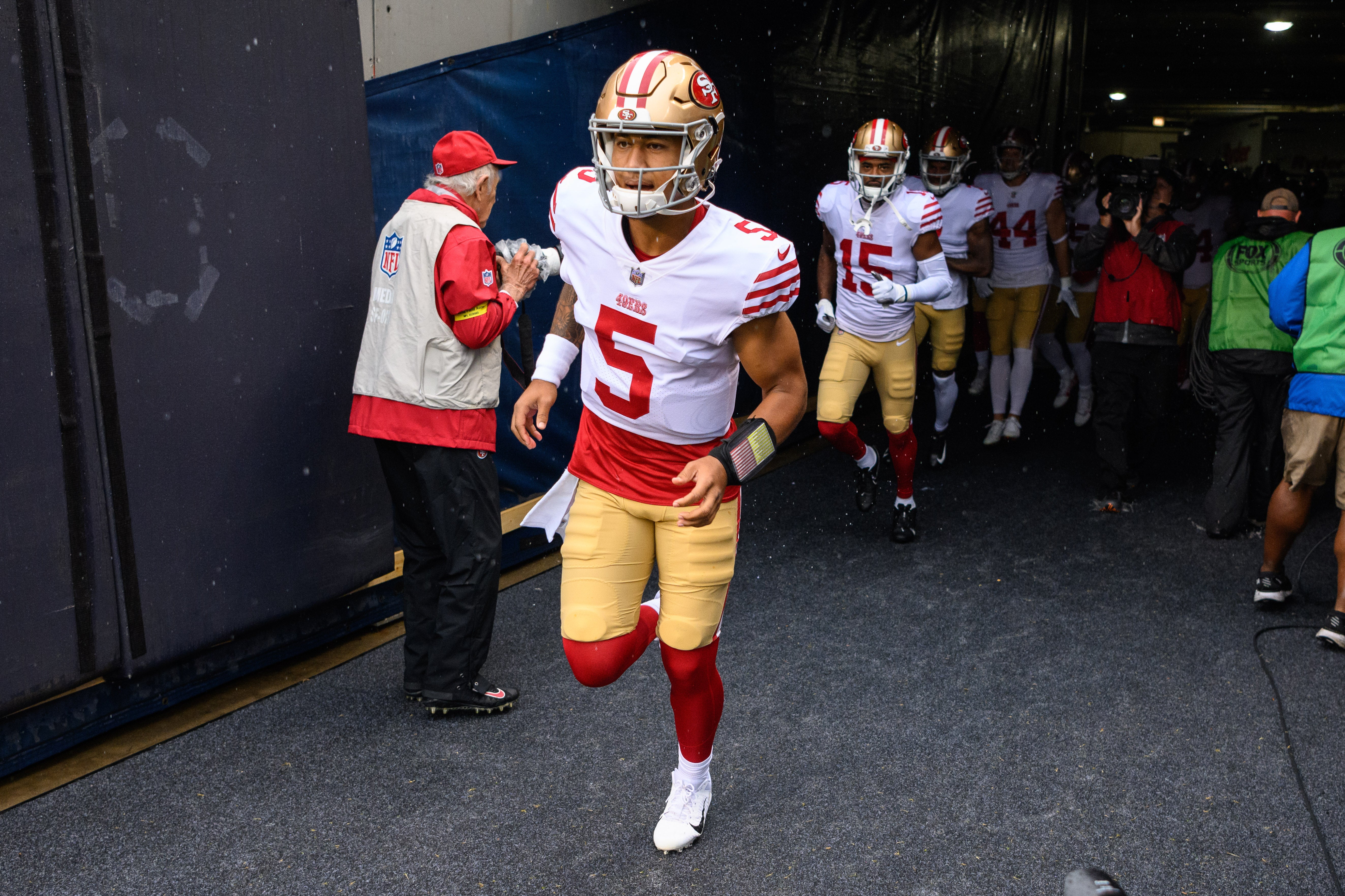 Sep 11, 2022; Chicago, Illinois, USA; San Francisco 49ers quarterback Trey Lance (5) leads his team onto the field before the game against the Chicago Bears at Soldier Field. Mandatory Credit: Daniel Bartel-USA TODAY Sports