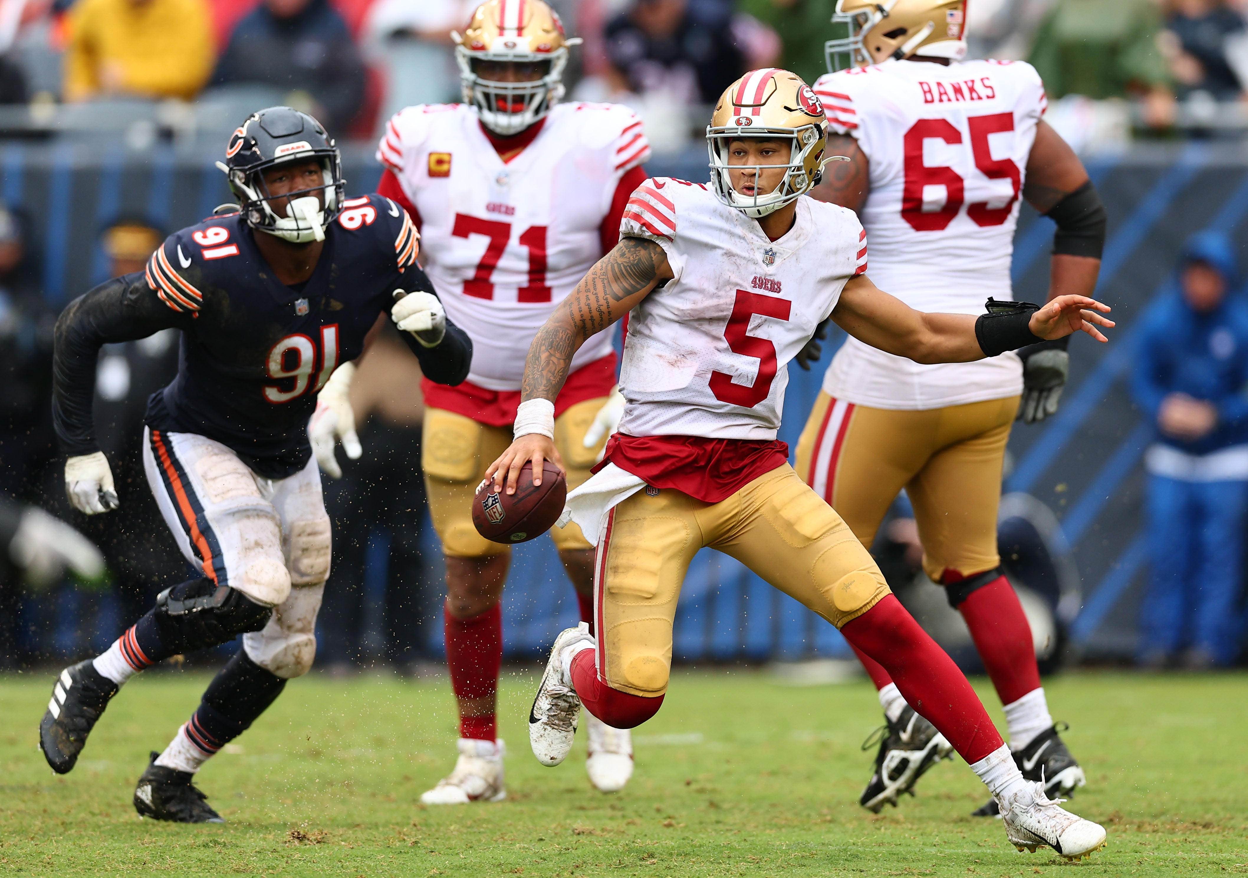 Sep 11, 2022; Chicago, Illinois, USA; San Francisco 49ers quarterback Trey Lance (5) rushes the ball against the Chicago Bears during the second half at Soldier Field.