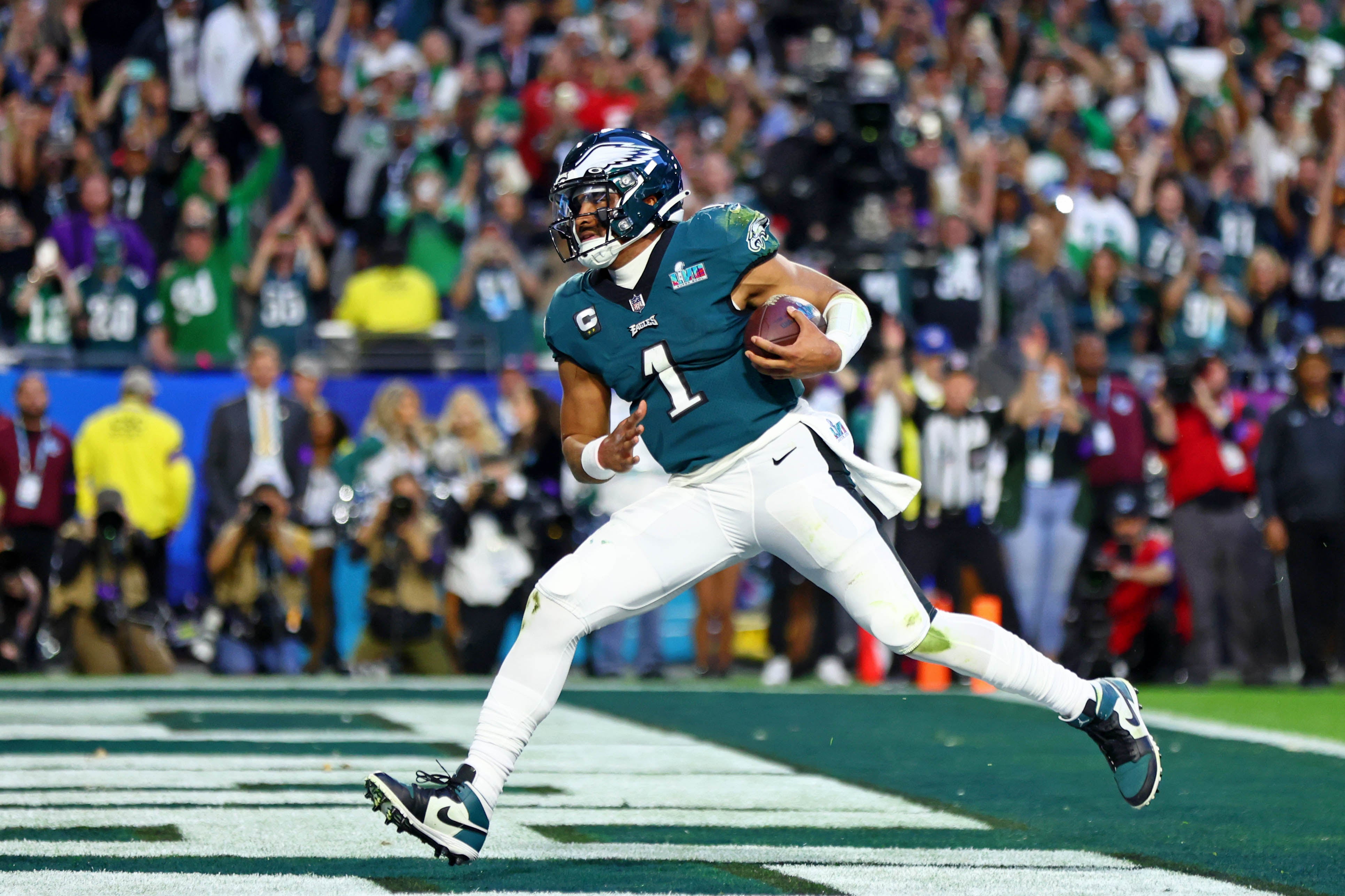 Feb 12, 2023; Glendale, Arizona, US; Philadelphia Eagles quarterback Jalen Hurts (1) runs with the ball for a touchdown against the Kansas City Chiefs during the second quarter of Super Bowl LVII at State Farm Stadium.