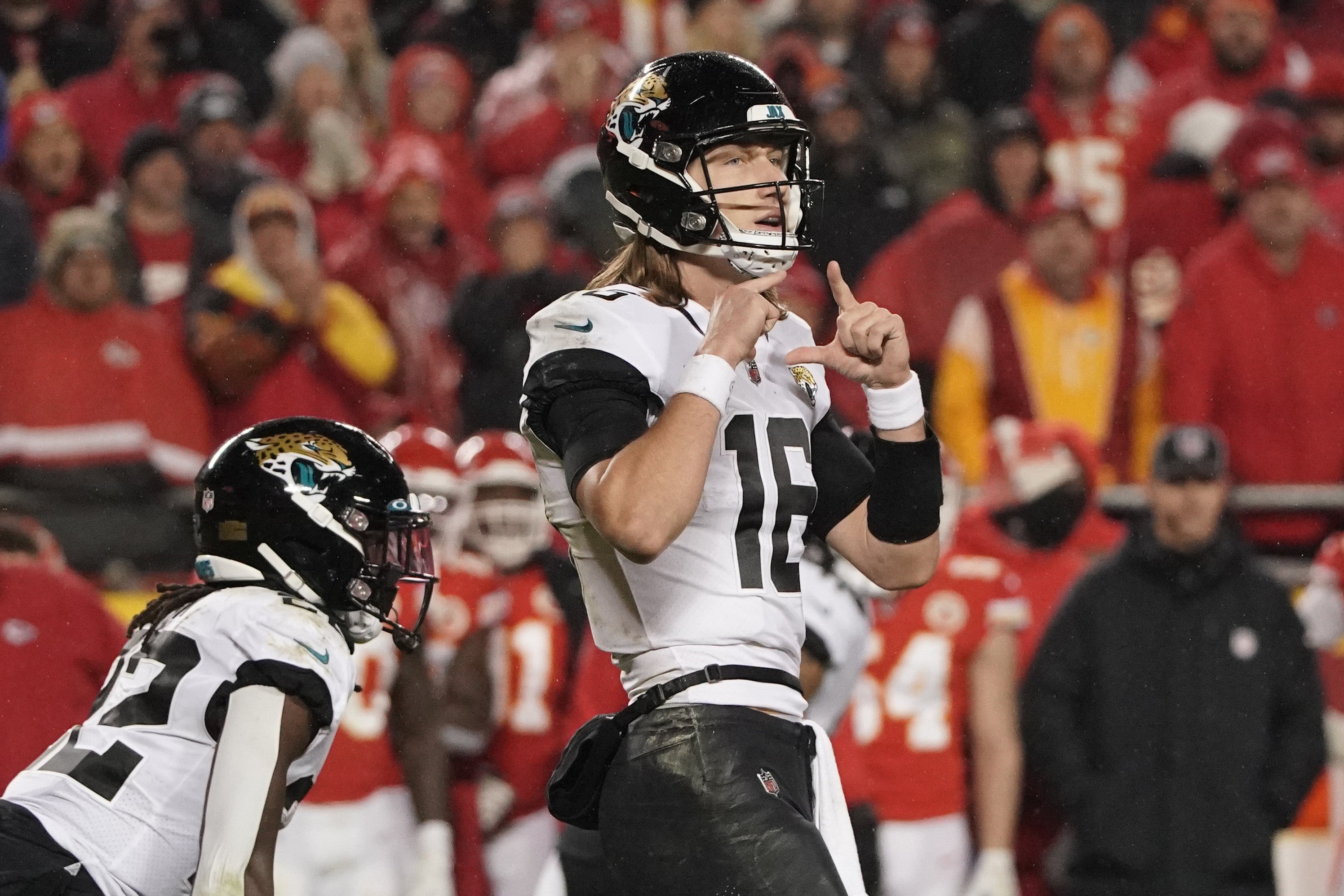 Jacksonville Jaguars quarterback Trevor Lawrence looking over at the sidelines during playoff game vs. KC Chiefs.