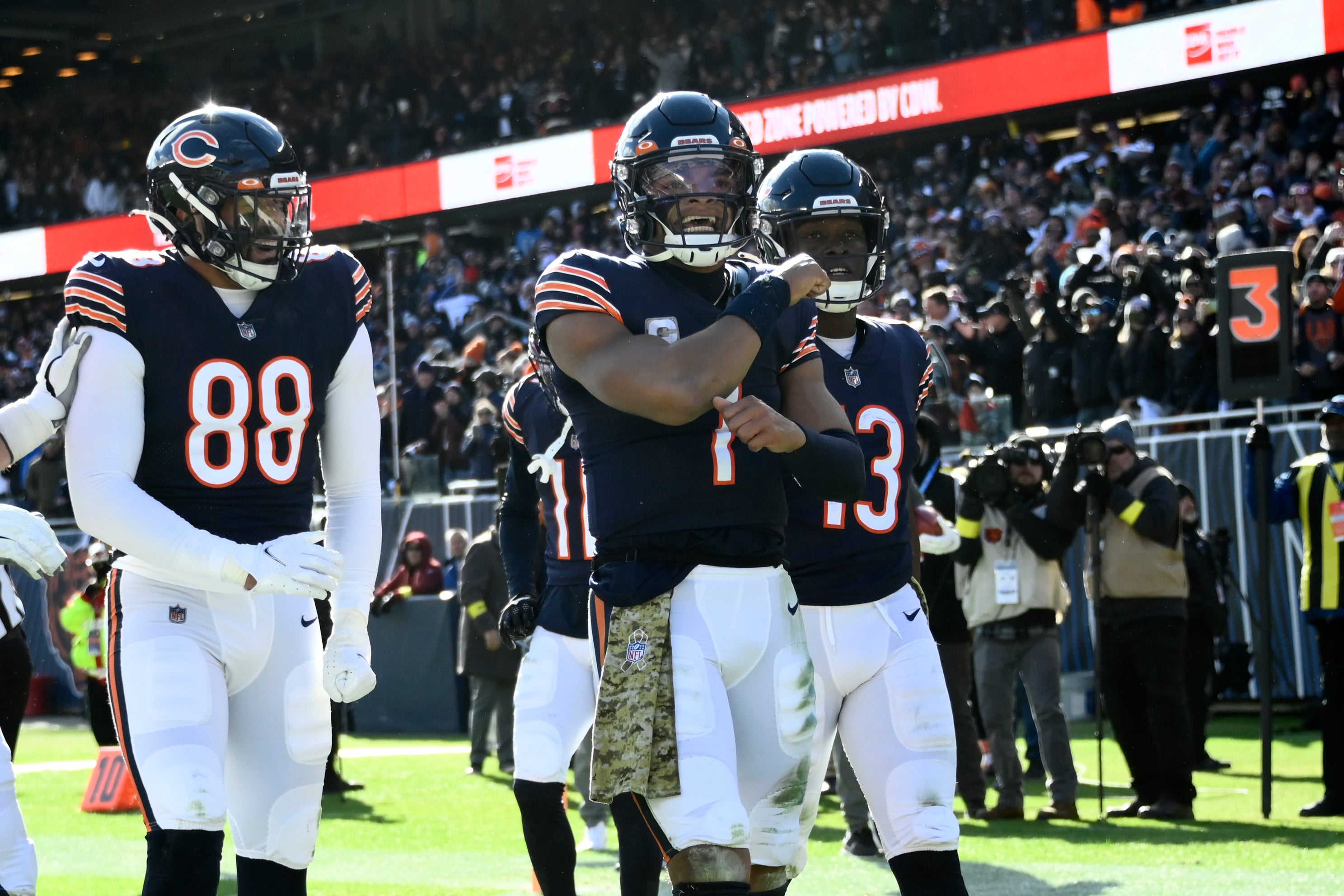 Nov 13, 2022; Chicago, Illinois, USA; Chicago Bears quarterback Justin Fields (1) celebrates with tight end Trevon Wesco (88) and wide receiver Byron Pringle (13) after he scores a touchdown against the Detroit Lions during the first half at Soldier Field.
