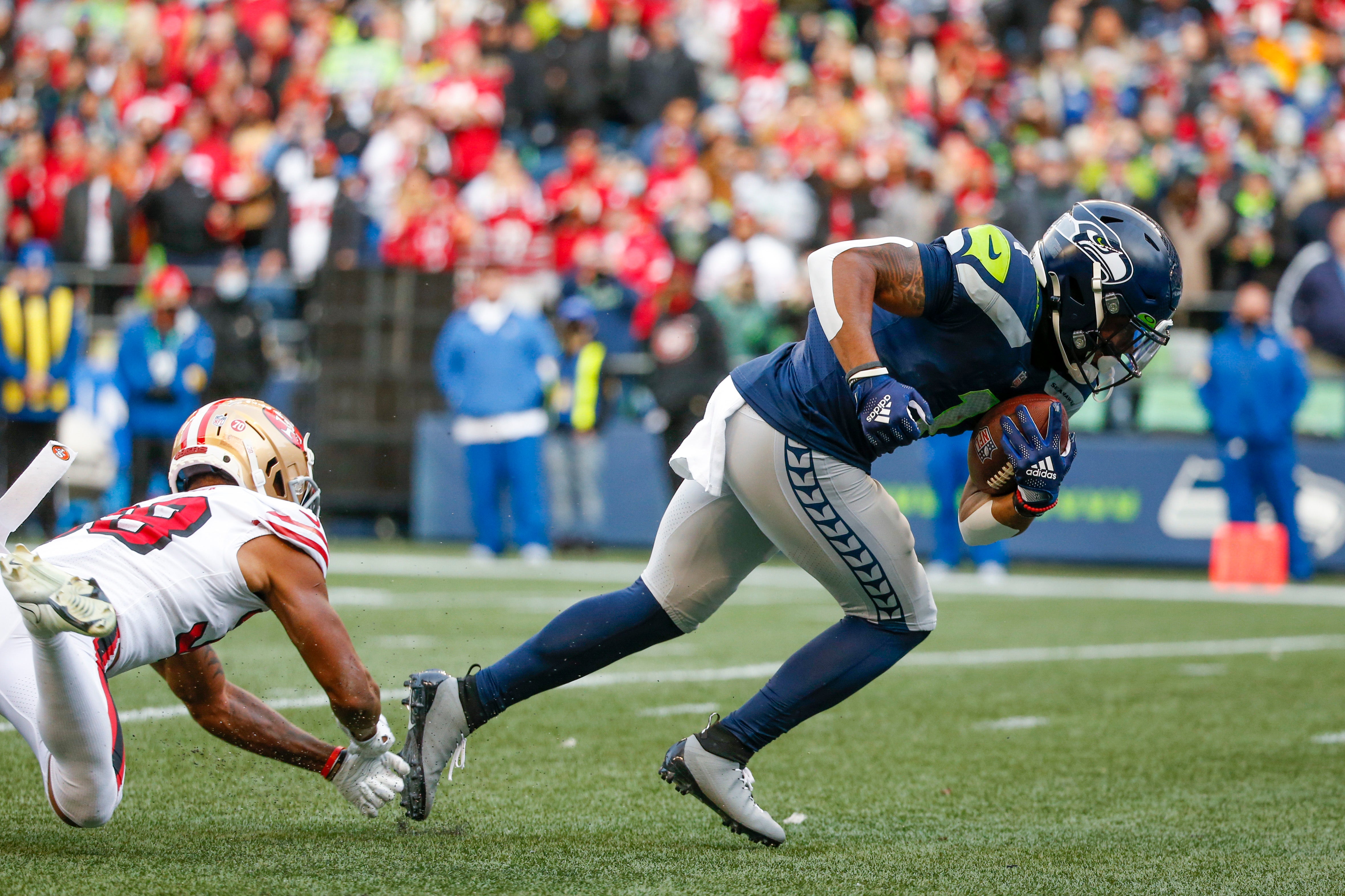 Dec 5, 2021; Seattle, Washington, USA; Seattle Seahawks wide receiver D'Wayne Eskridge (1) breaks a tackle to score a touchdown against the San Francisco 49ers during the second quarter at Lumen Field.