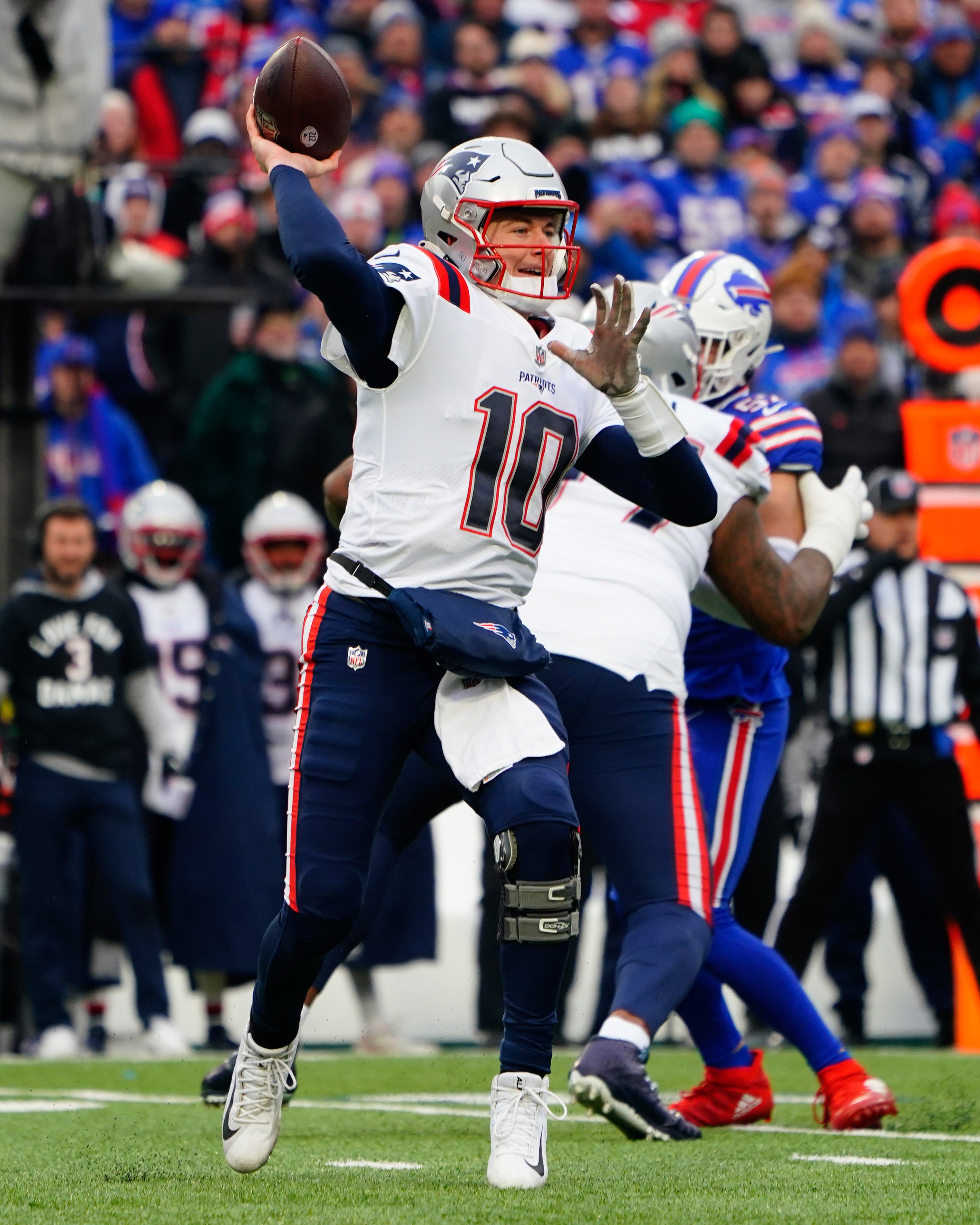 Jan 8, 2023; Orchard Park, New York, USA; New England Patriots quarterback Mac Jones (10) throws the ball against the Buffalo Bills during the first half at Highmark Stadium.