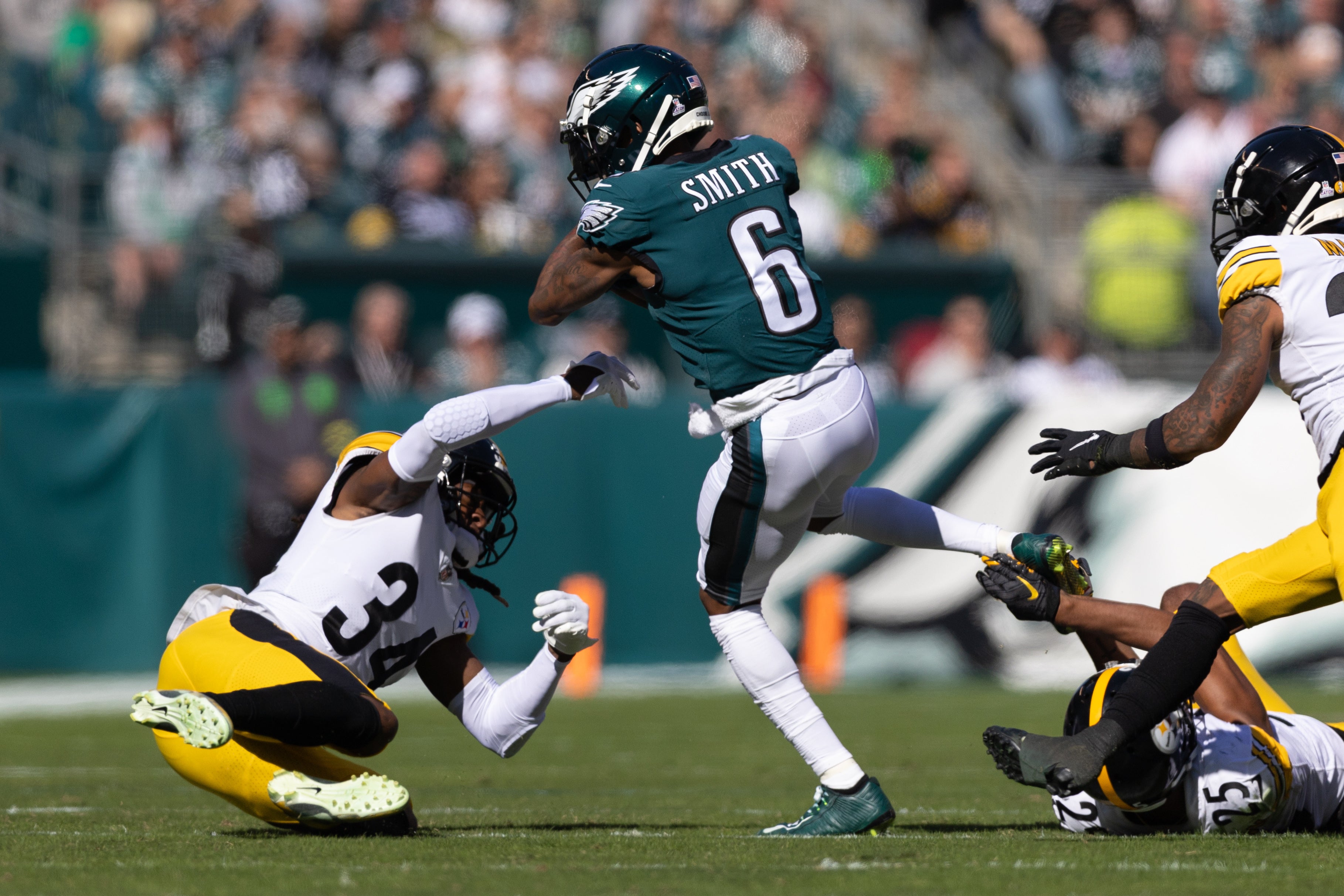 Oct 30, 2022; Philadelphia, Pennsylvania, USA; Philadelphia Eagles wide receiver DeVonta Smith (6) makes a catch between Pittsburgh Steelers safety Terrell Edmunds (34) and cornerback Ahkello Witherspoon (25) during the first quarter at Lincoln Financial Field.