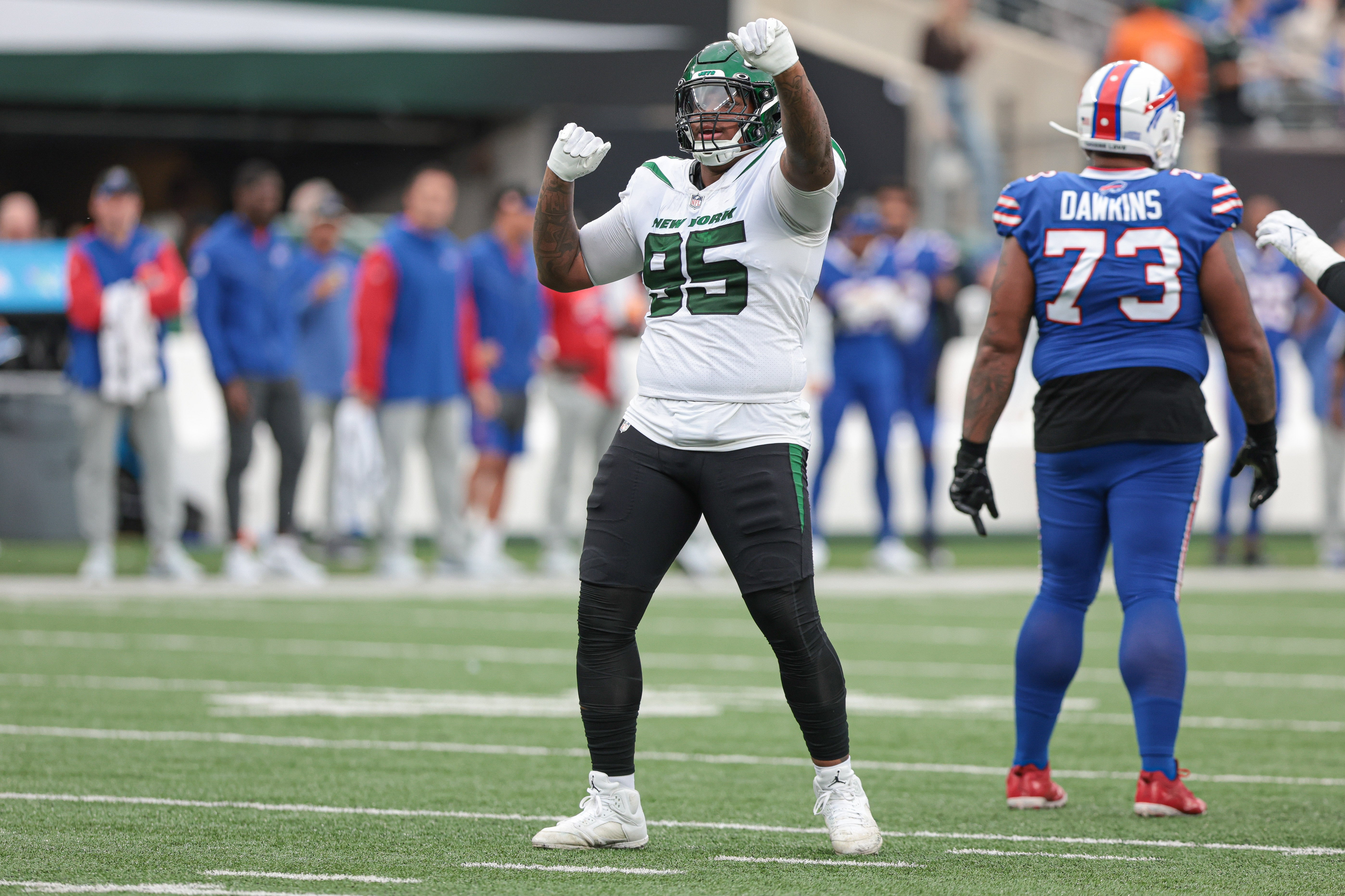Nov 6, 2022; East Rutherford, New Jersey, USA; New York Jets defensive tackle Quinnen Williams (95) celebrates a defensive stop being Buffalo Bills offensive tackle Dion Dawkins (73) during the second half at MetLife Stadium.