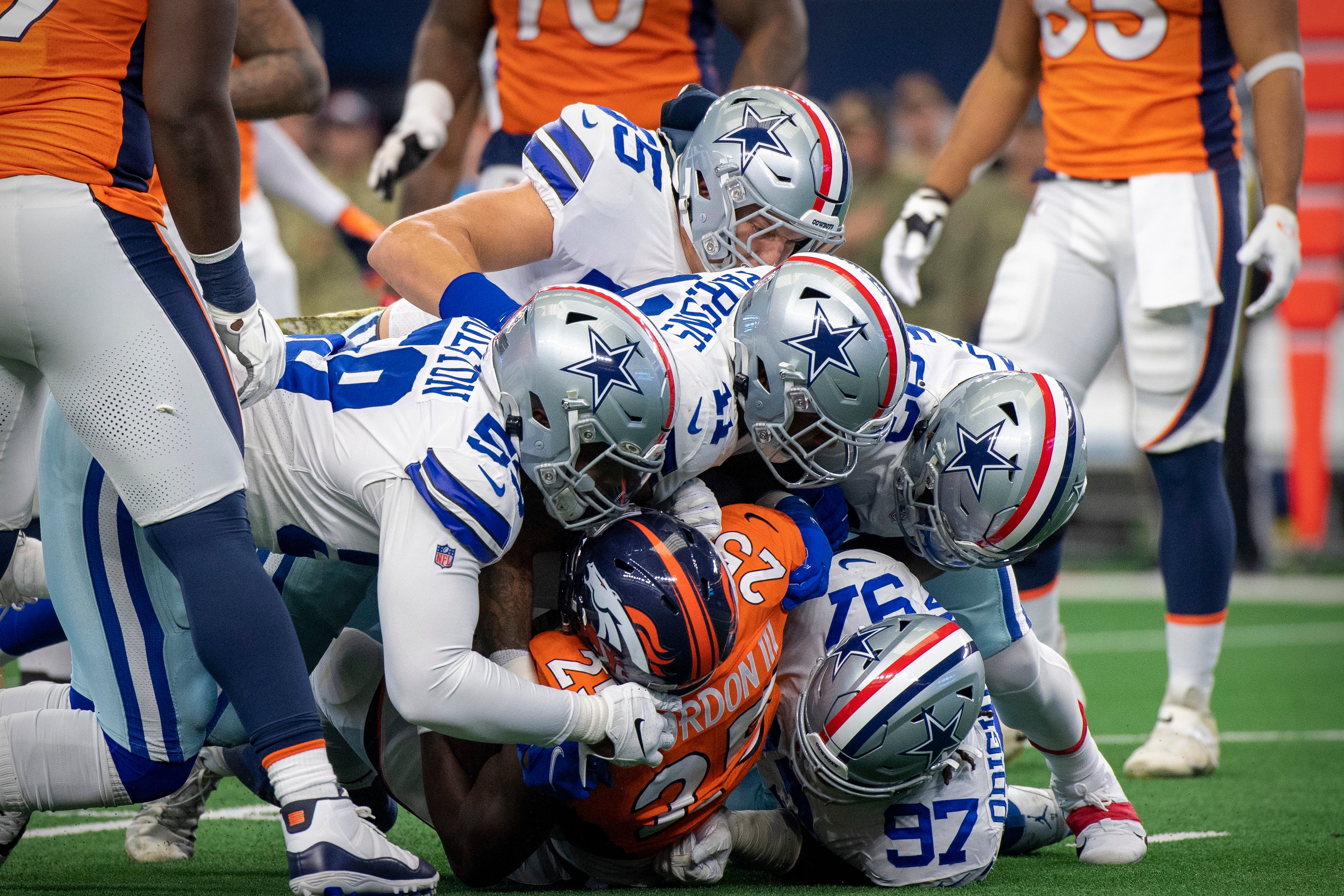Dallas Cowboys defense piling on Denver Broncos RB.