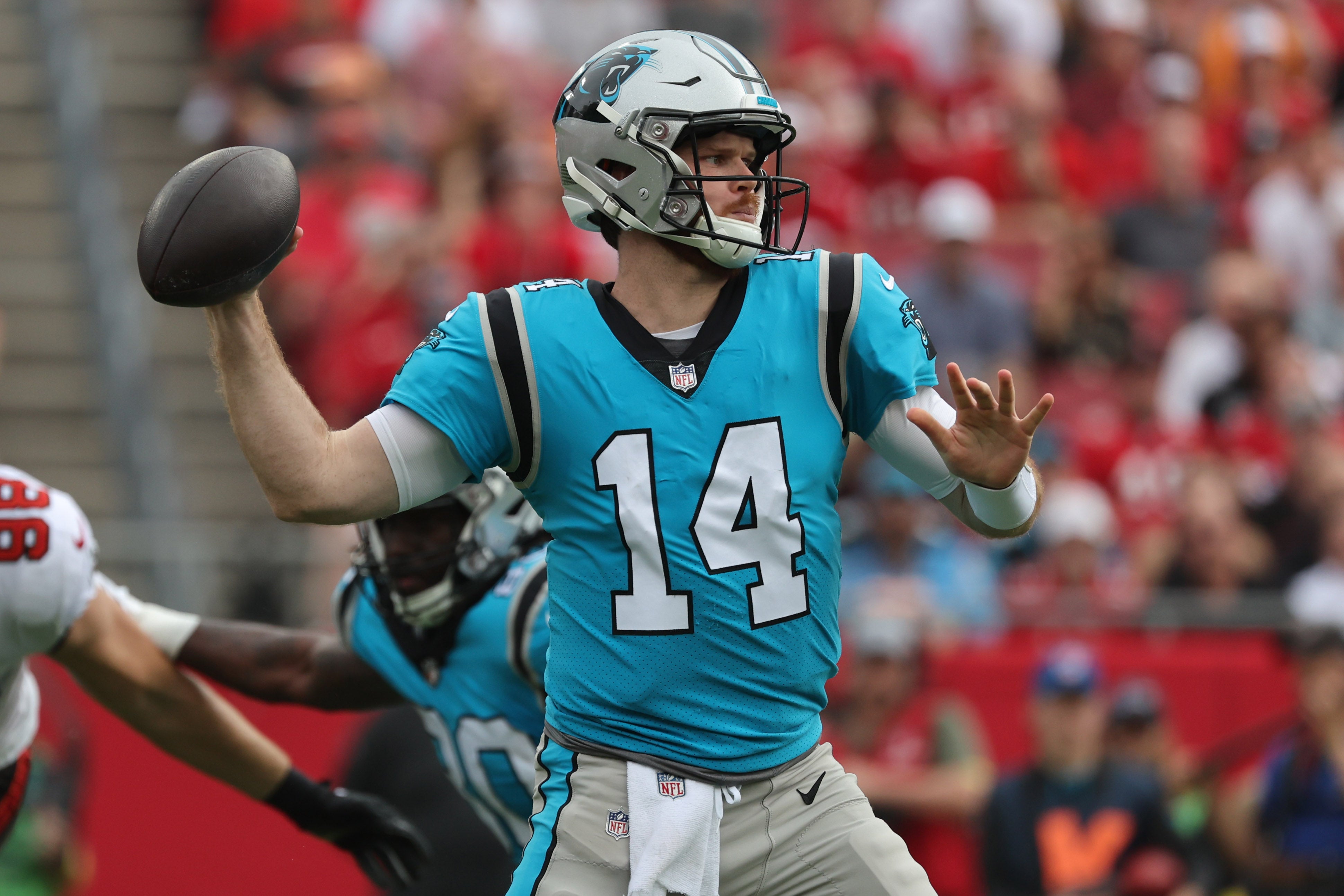 Jan 1, 2023; Tampa, Florida, USA; Carolina Panthers quarterback Sam Darnold (14) drops back against the Tampa Bay Buccaneers during the first quarter at Raymond James Stadium.