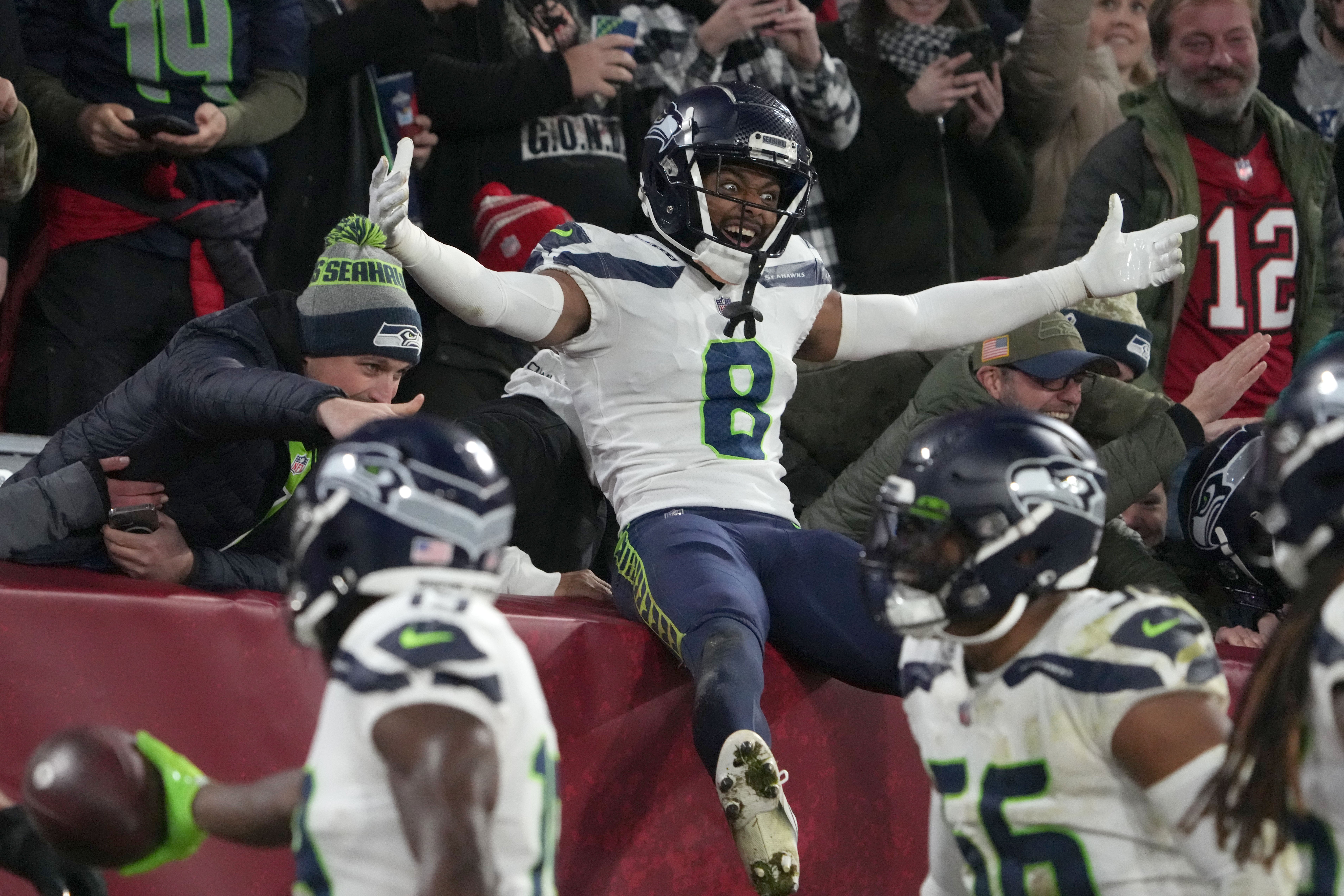 Nov 13, 2022; Munich, Germany; Seattle Seahawks cornerback Coby Bryant (8) celebrates with fans in the second half against the Tampa Bay Buccaneers during an NFL International Series game at Allianz Arena. Mandatory Credit: Kirby Lee-USA TODAY Sports