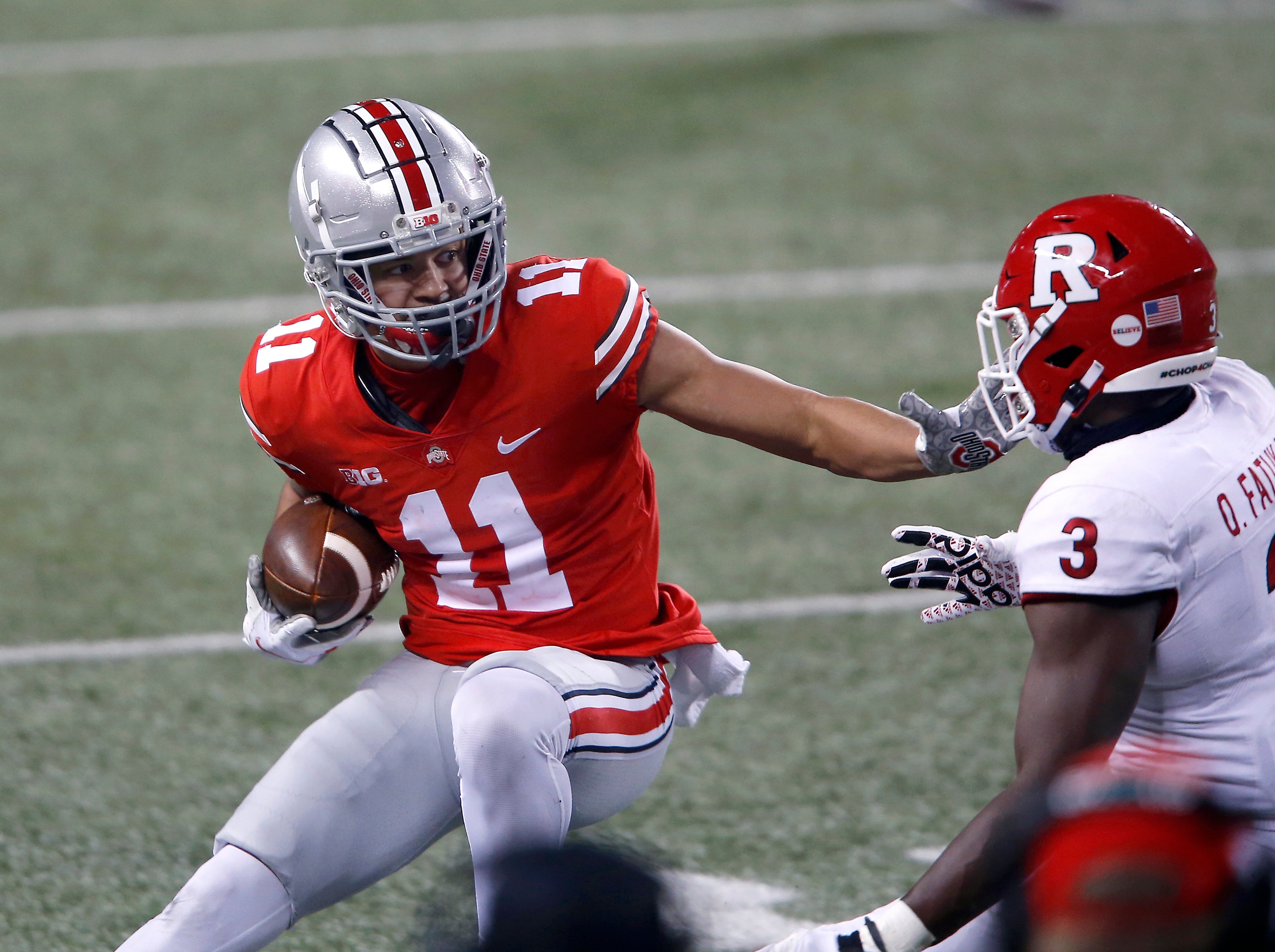 Nov 7, 2020; Columbus, Ohio, USA; Ohio State Buckeyes wide receiver Jaxon Smith-Njigba (11)runs as he is tackled by Rutgers Scarlet Knights linebacker Olakunle Fatukasi (3)during the third quarter at Ohio Stadium.