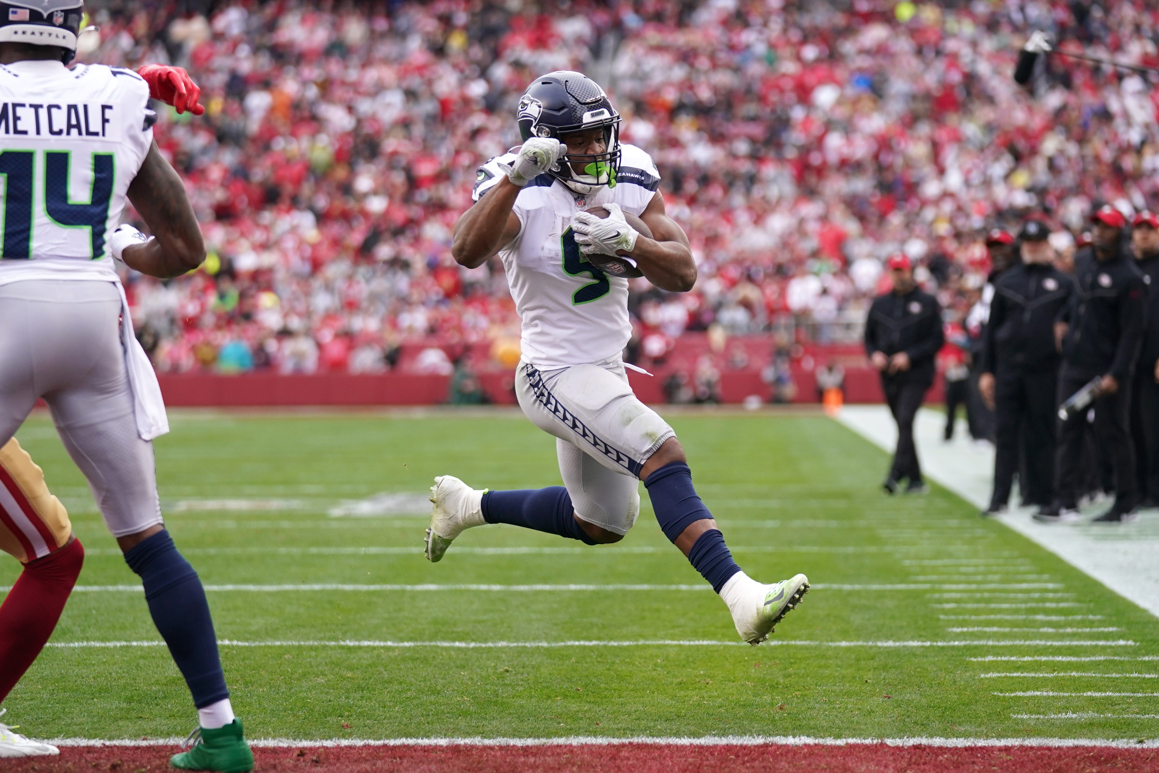 Jan 14, 2023; Santa Clara, California, USA; Seattle Seahawks running back Kenneth Walker III (9) leaps into the end zone for a second quarter touchdown during a wild card game against the San Francisco 49ers at Levi's Stadium.
