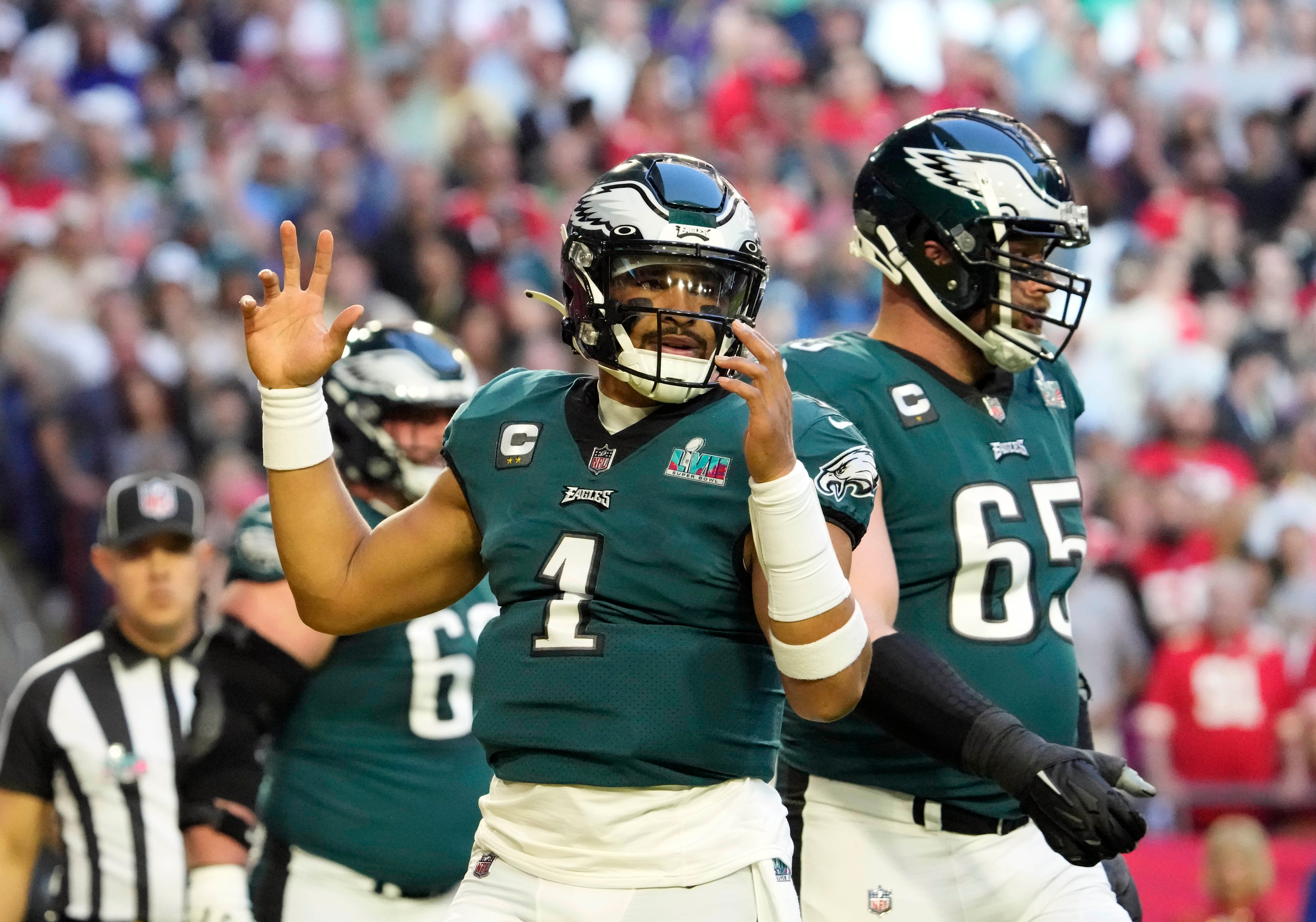 Feb 12, 2023; Glendale, AZ, USA; Philadelphia Eagles quarterback Jalen Hurts (1) celebrates after scoring a touchdown against the Kansas City Chiefs during the first quarter in Super Bowl LVII at State Farm Stadium.
