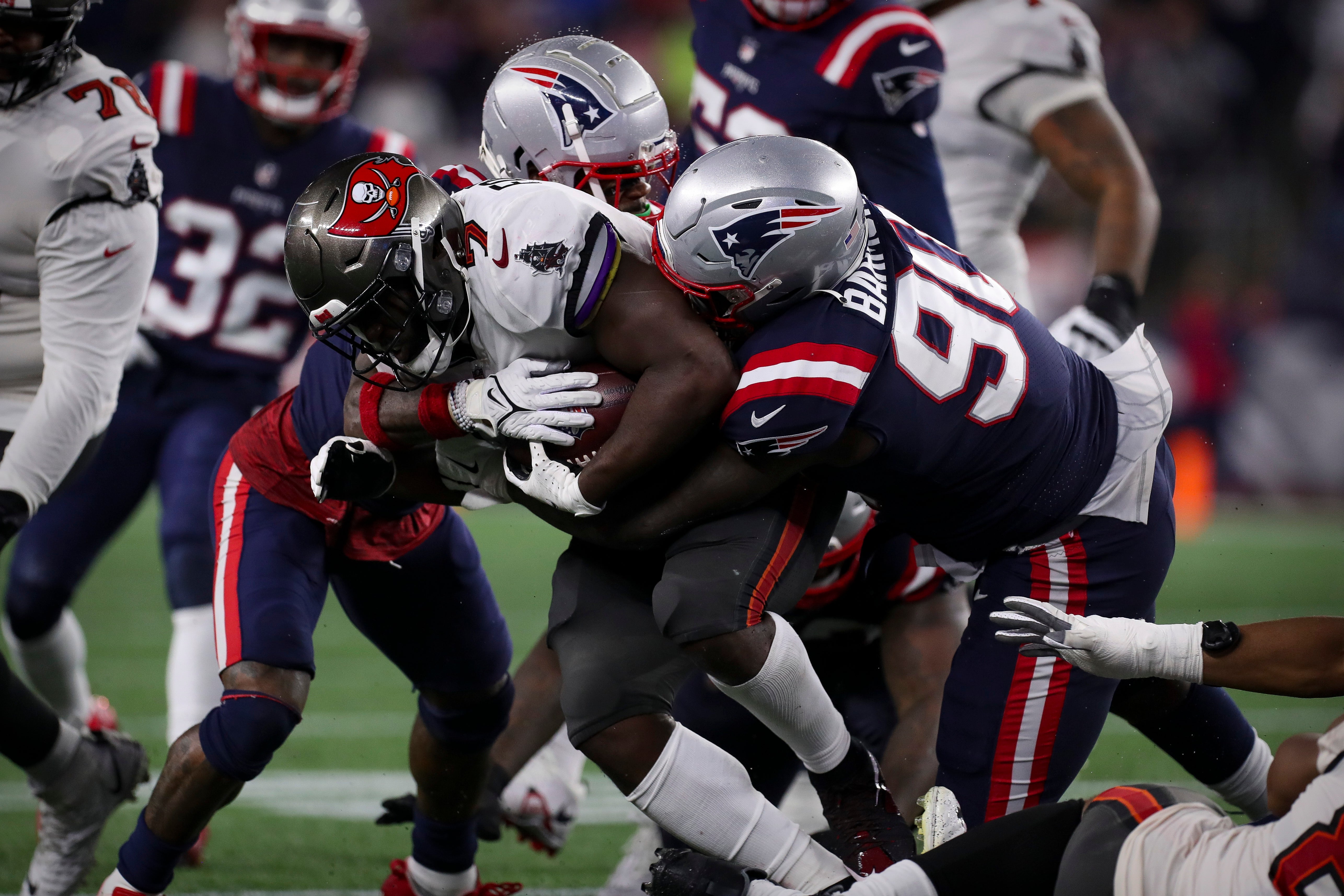 Oct 3, 2021; Foxboro, MA, USA; Tampa Bay Buccaneers running back Leonard Fournette (7) is brought down by New England Patriots defensive tackle Christian Barmore (90) during the second half at Gillette Stadium.