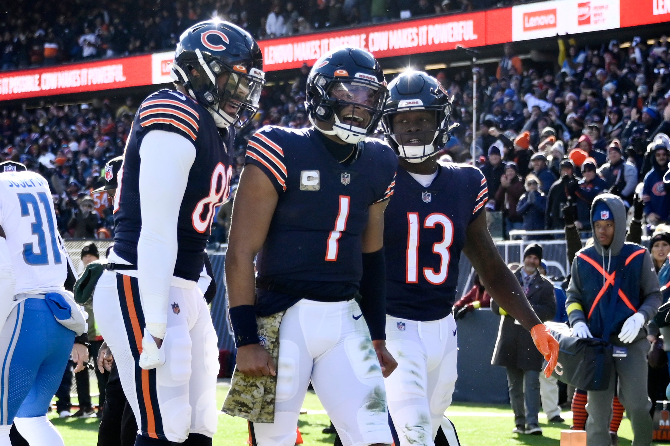 Nov 13, 2022; Chicago, Illinois, USA; Chicago Bears quarterback Justin Fields (1) celebrates with tight end Trevon Wesco (88) and wide receiver Byron Pringle (13) after he scores a touchdown against the Detroit Lions during the first half at Soldier Field.