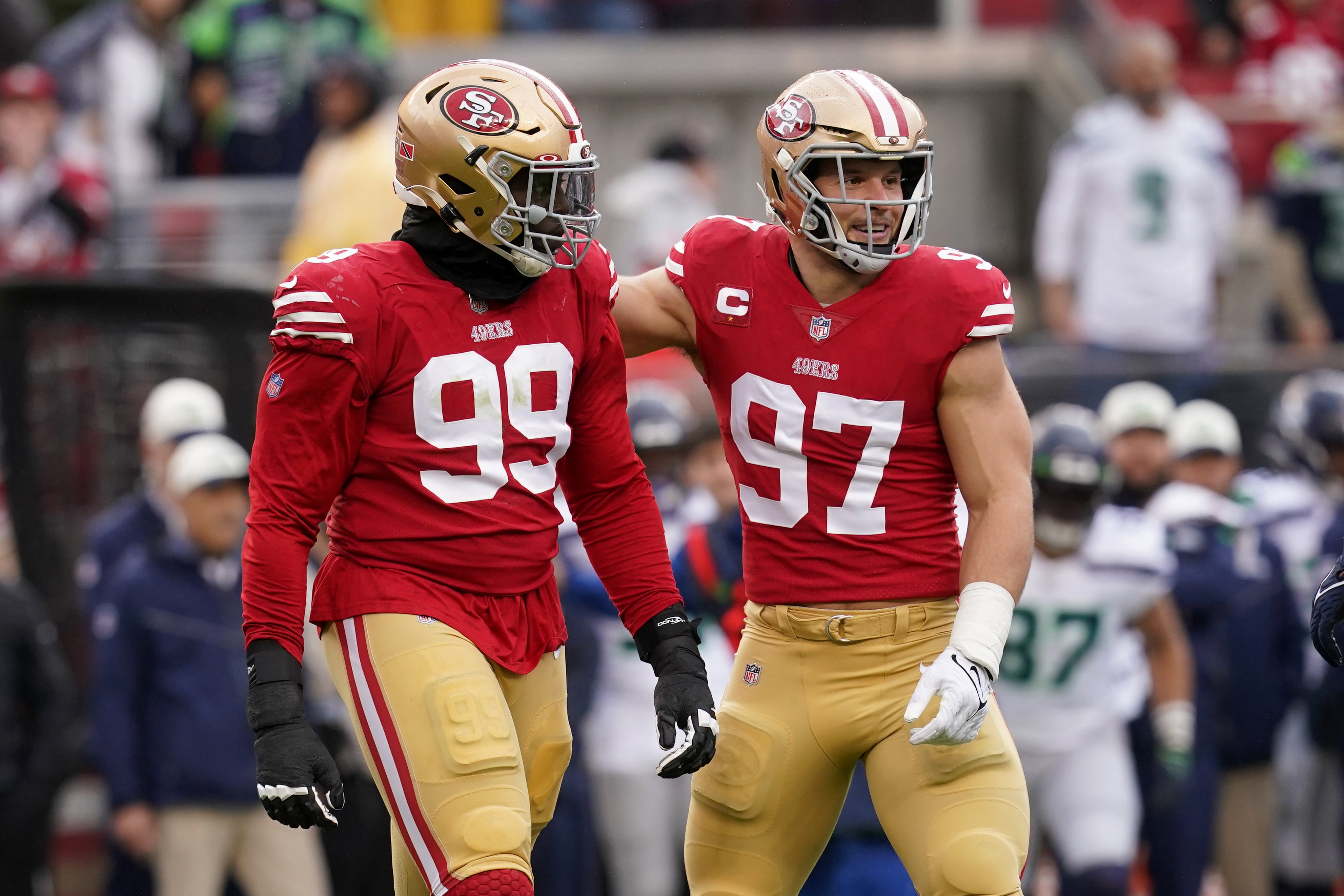 Jan 14, 2023; Santa Clara, California, USA; San Francisco 49ers defensive tackle Javon Kinlaw (99) and defensive end Nick Bosa (97) react after a play in the first quarter during a wild card game against the Seattle Seahawks at Levi's Stadium. Mandatory Credit: Cary Edmondson-USA TODAY Sports