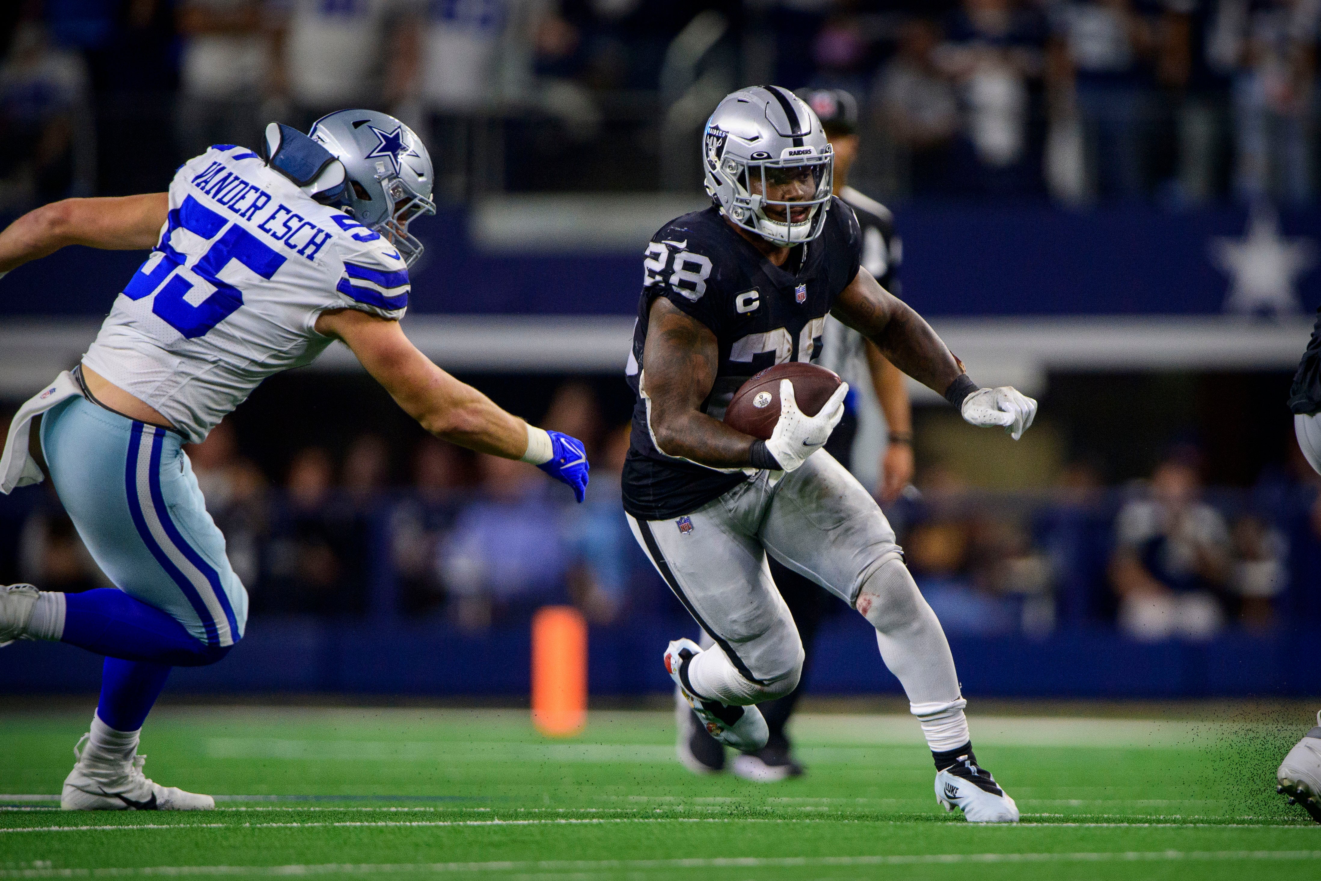 Nov 25, 2021; Arlington, Texas, USA; Dallas Cowboys outside linebacker Leighton Vander Esch (55) and Las Vegas Raiders running back Josh Jacobs (28) in action during the game between the Dallas Cowboys and the Las Vegas Raiders at AT&T Stadium.