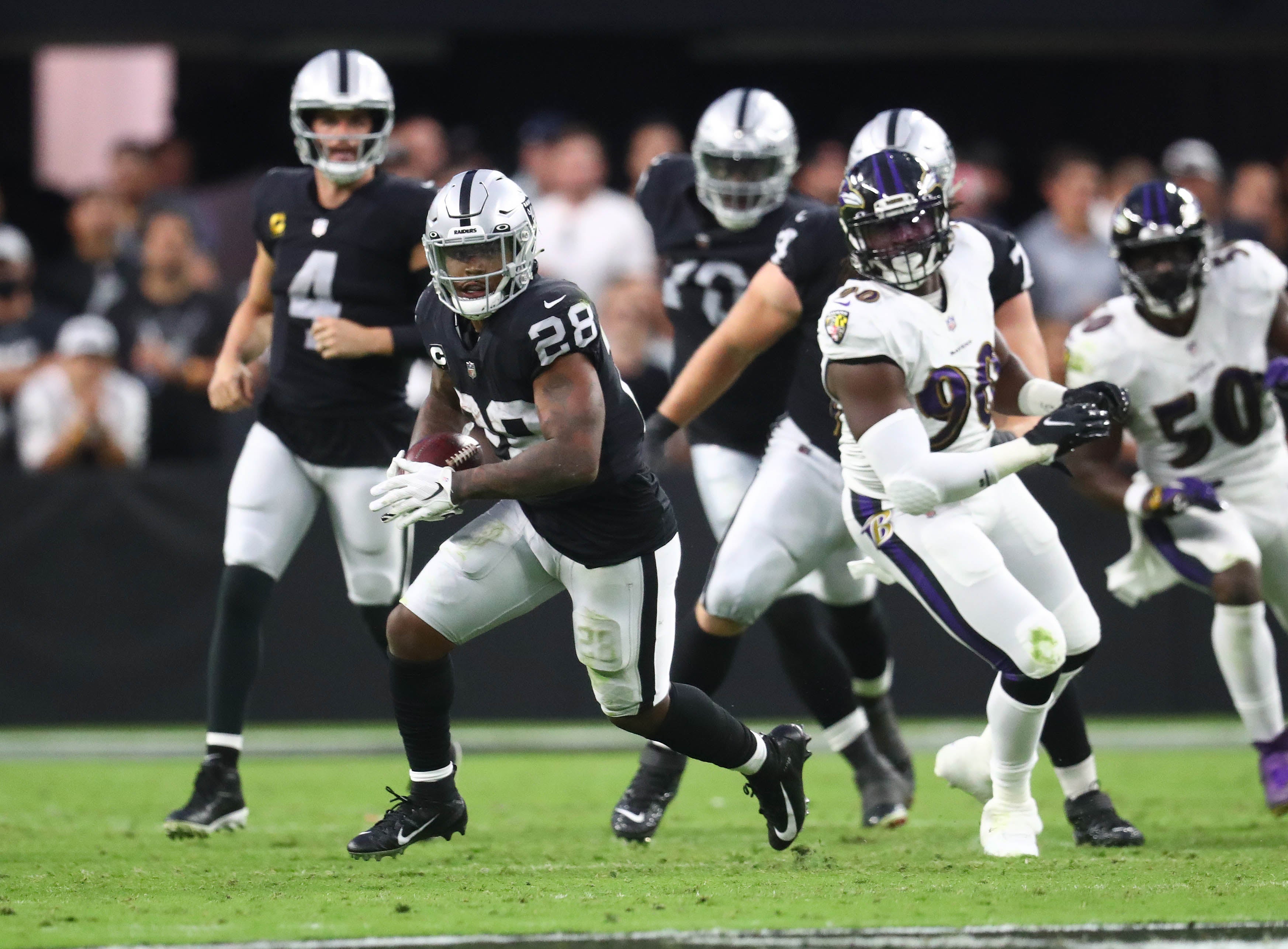 Sep 13, 2021; Paradise, Nevada, USA; Las Vegas Raiders running back Josh Jacobs (28) runs the ball against the Baltimore Ravens during the first half at Allegiant Stadium.