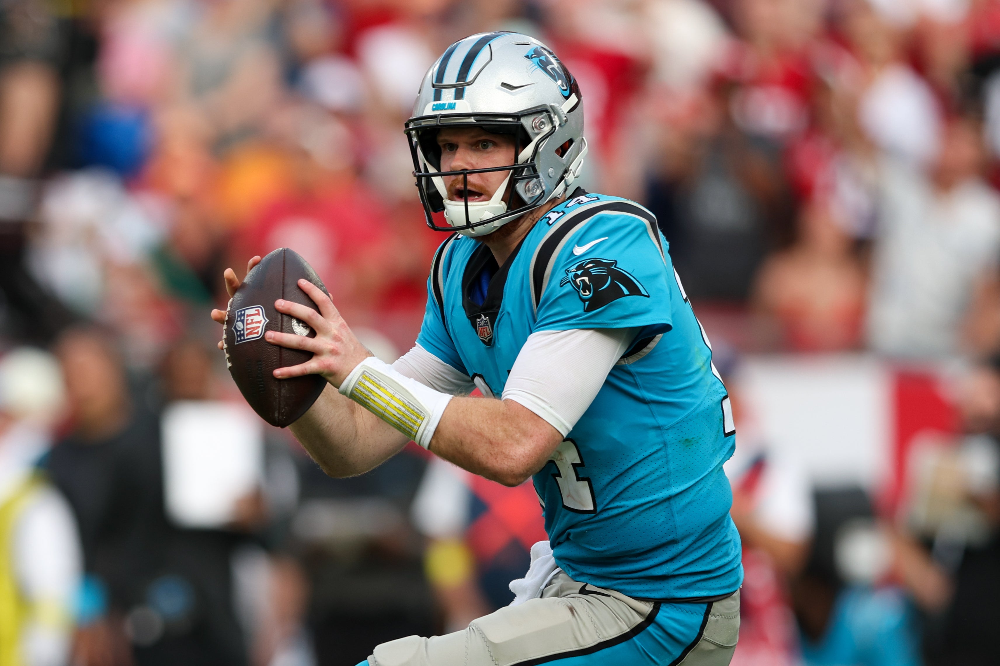 Caption:Jan 1, 2023; Tampa, Florida, USA; Carolina Panthers quarterback Sam Darnold (14) drops back to pass against the Tampa Bay Buccaneers in the fourth quarter at Raymond James Stadium.