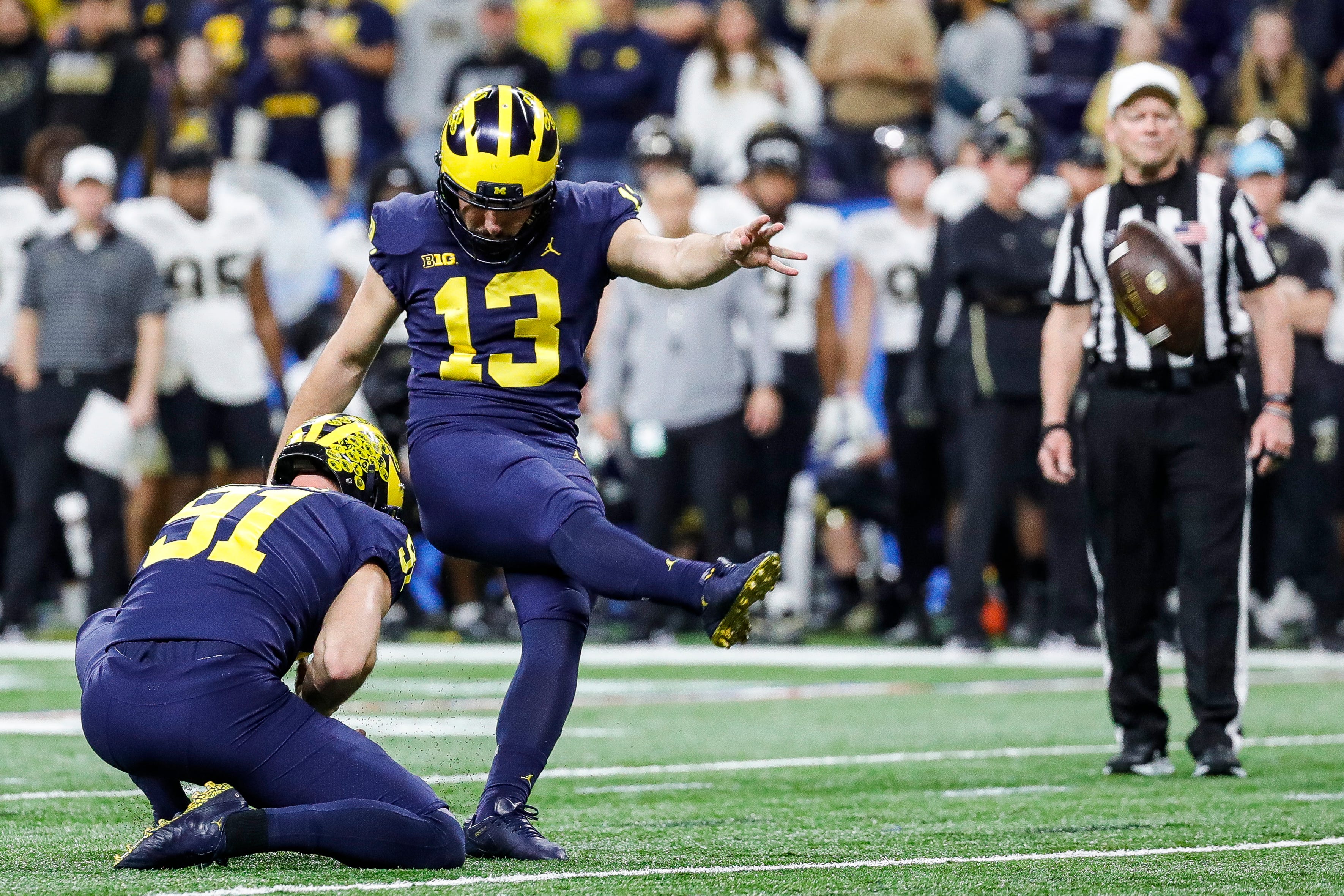 Michigan place kicker Jake Moody (13) attempts an extra point against Purdue during the second half of the Big Ten Championship game at Lucas Oil Stadium in Indianapolis, Ind., on Saturday, Dec. 3, 2022.
