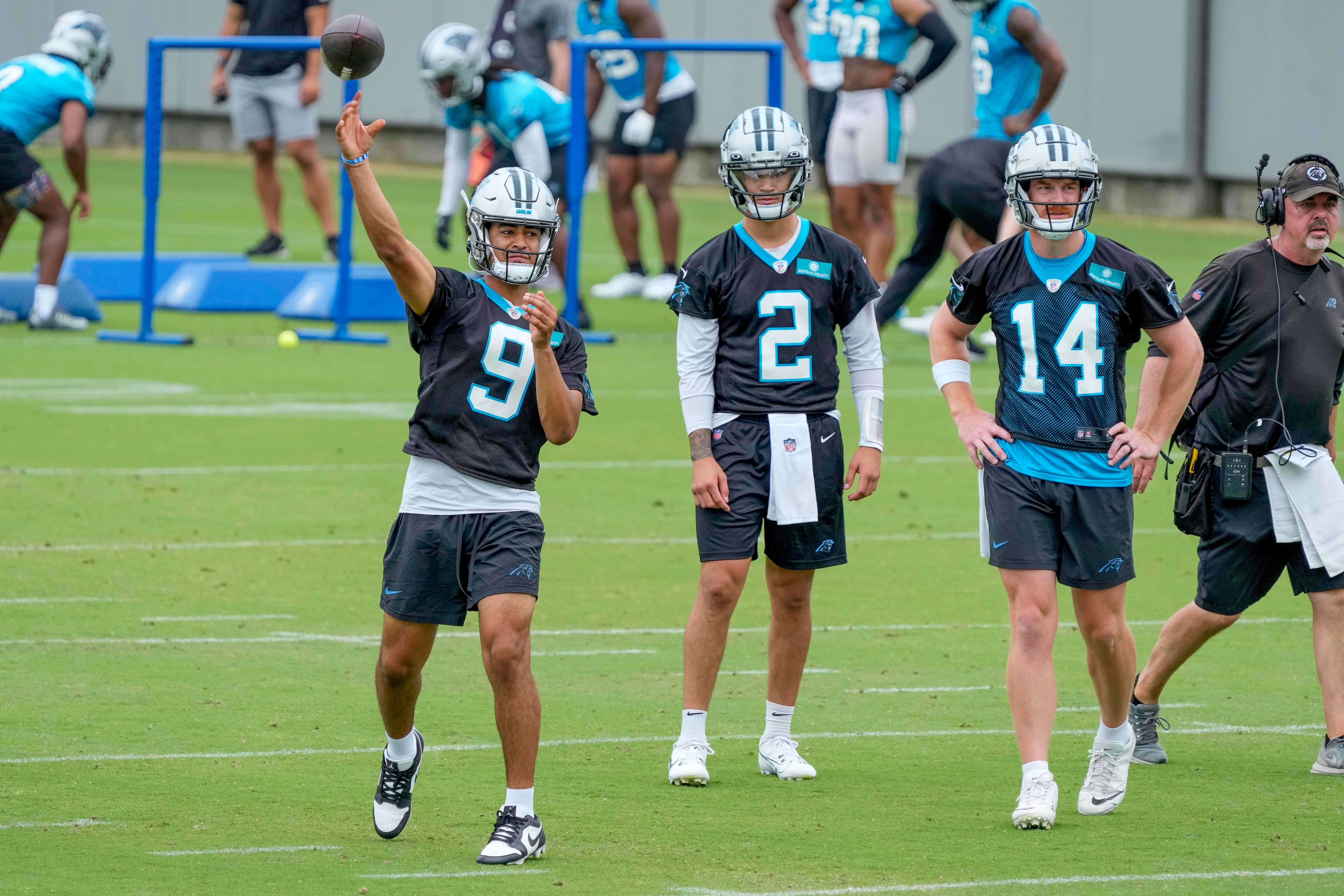 Jun 14, 2023; Charlotte, NC, USA; Carolina Panthers quarterback Bryce Young (9) throws with quarterback Matt Corral (2) and quarterback Andy Dalton (14) watching during the Carolina Panthers minicamp.