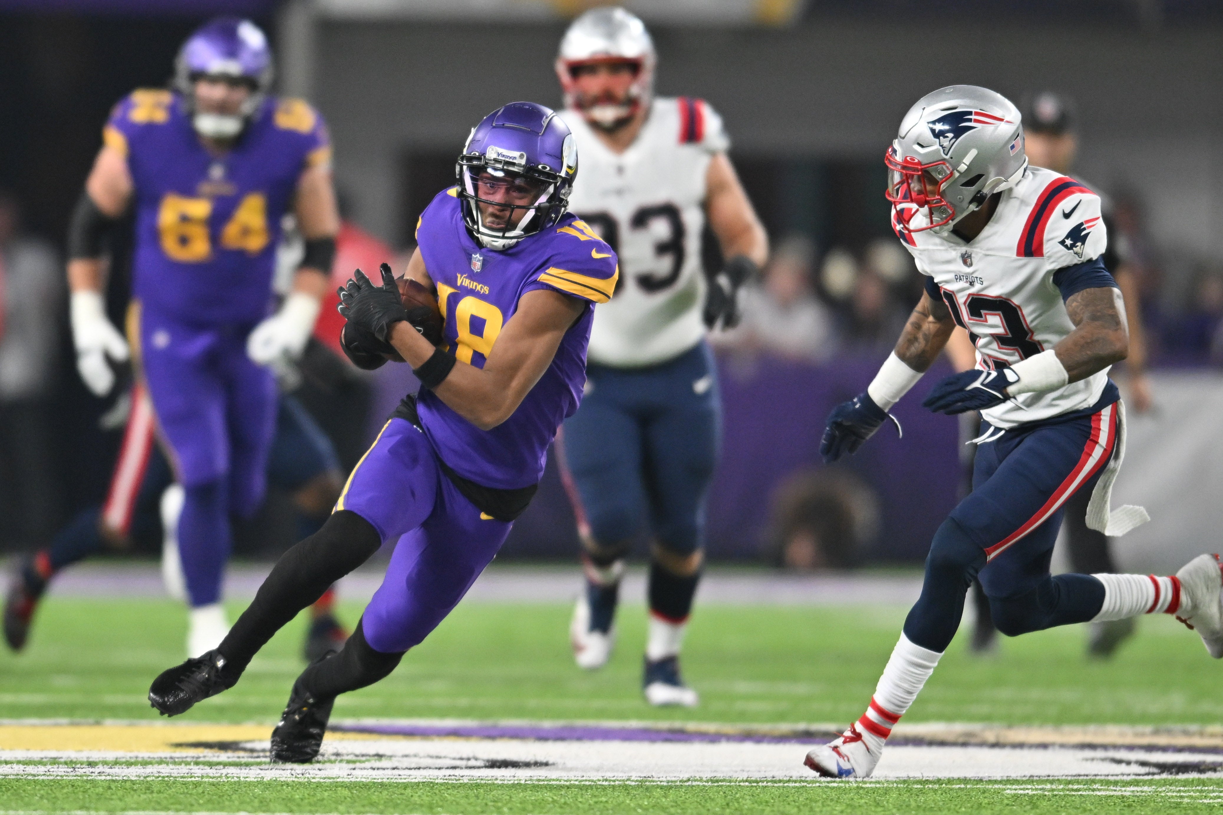 Nov 24, 2022; Minneapolis, Minnesota, USA; Minnesota Vikings wide receiver Justin Jefferson (18) and New England Patriots cornerback Jack Jones (13) in action during the game at U.S. Bank Stadium