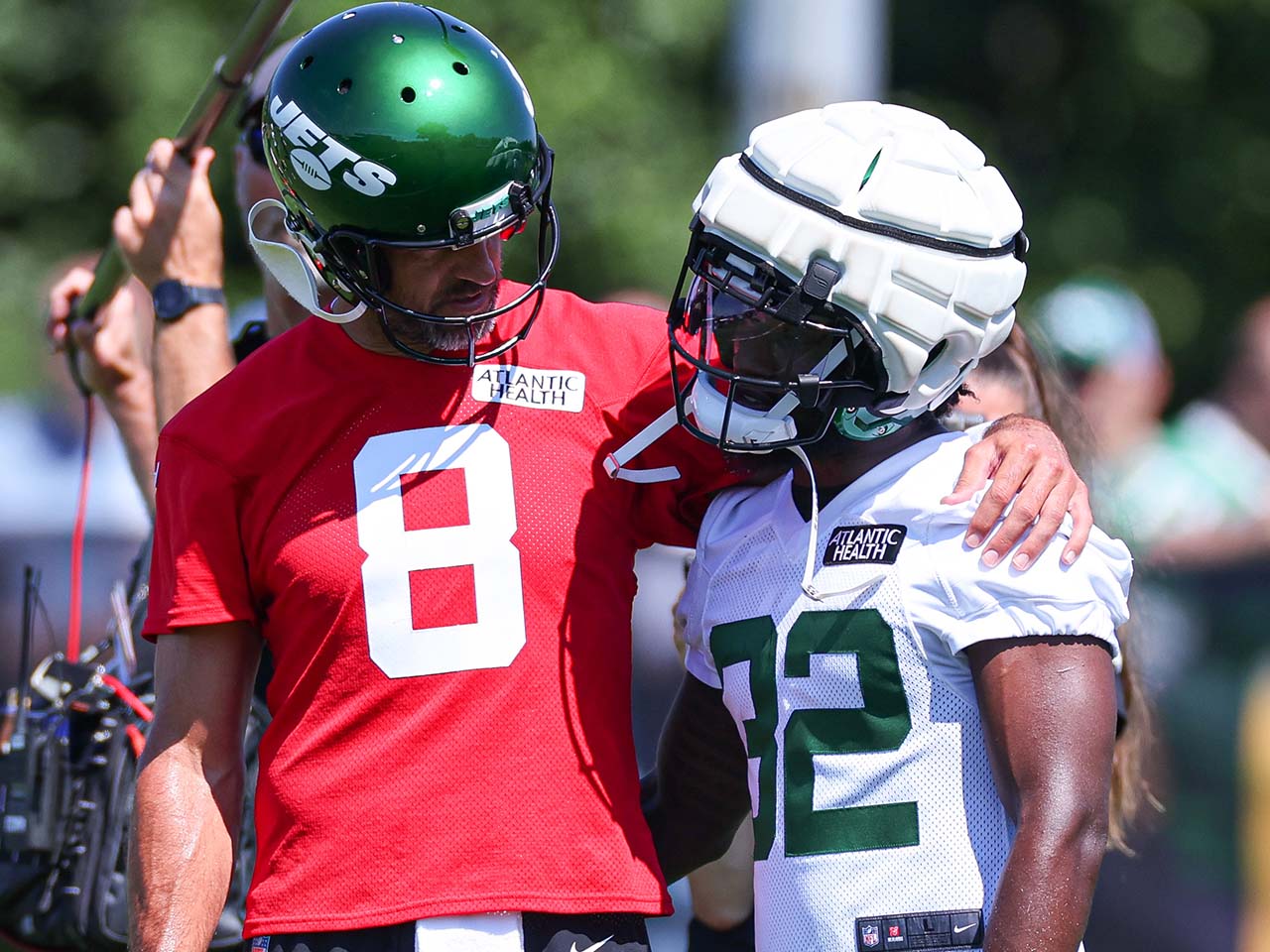 New York Jets quarterback Aaron Rodgers (8) talks with running back Michael Carter (32) during the New York Jets Training Camp at Atlantic Health Jets Training Center.