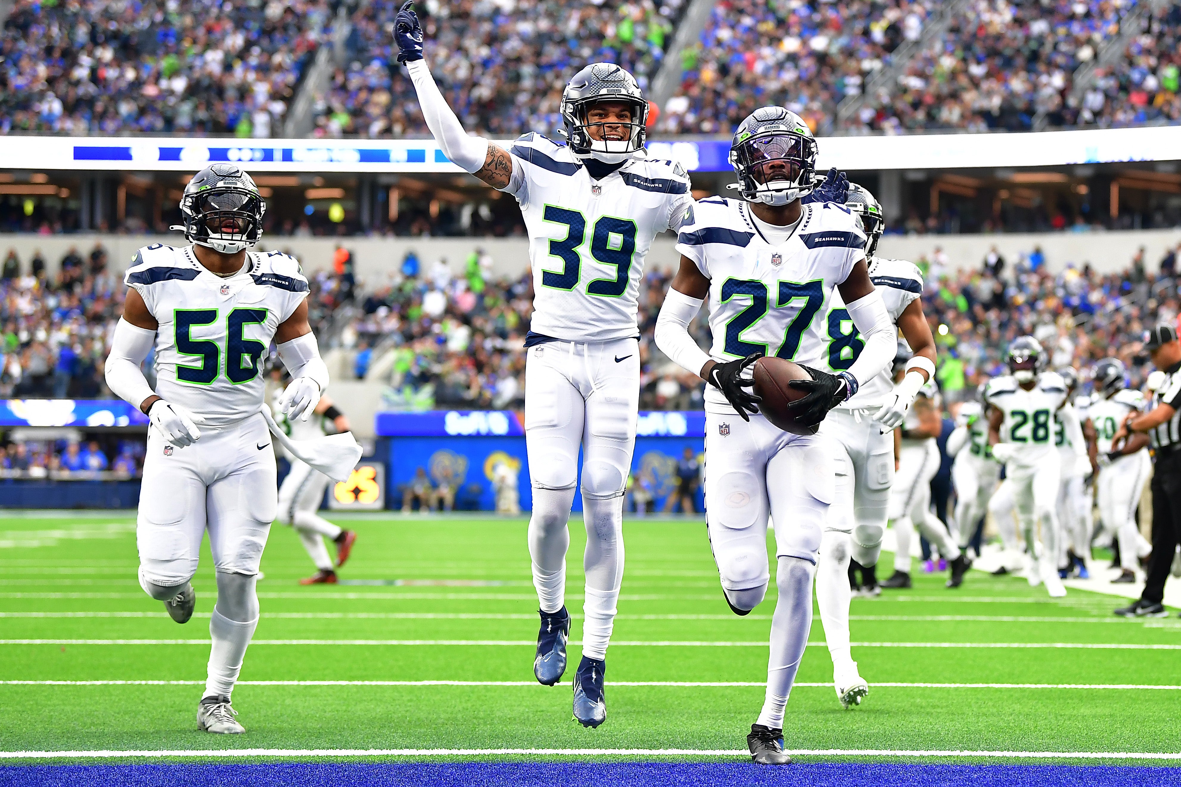 Dec 4, 2022; Inglewood, California, USA; Seattle Seahawks cornerback Tariq Woolen (27) celebrates after intercepting a pass intended for Los Angeles Rams running back Kyren Williams (23) during the first half at SoFi Stadium. Mandatory Credit: Gary A. Vasquez-USA TODAY Sports