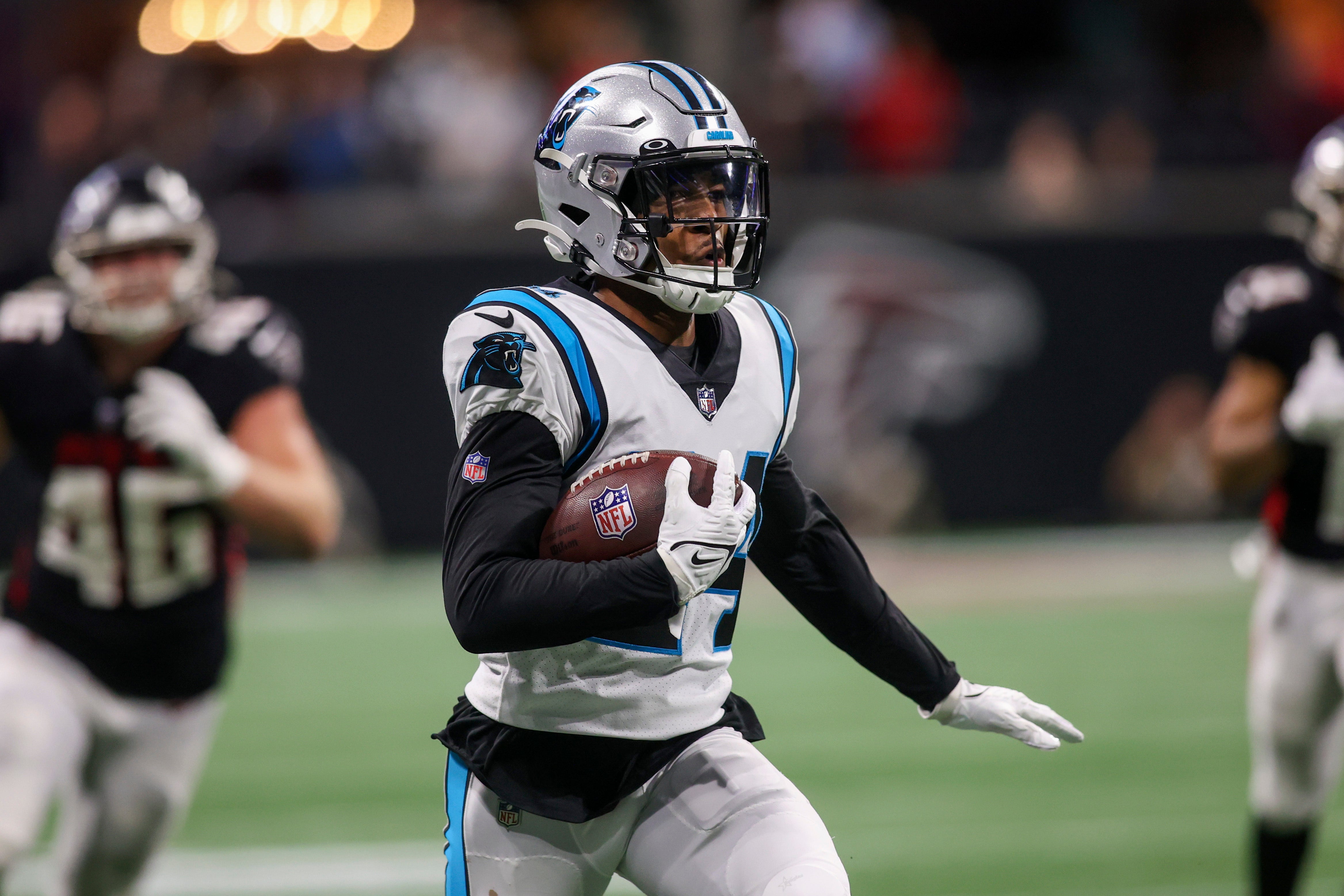 Caption:Oct 30, 2022; Atlanta, Georgia, USA; Carolina Panthers cornerback CJ Henderson (24) returns an interception against the Atlanta Falcons in overtime at Mercedes-Benz Stadium.