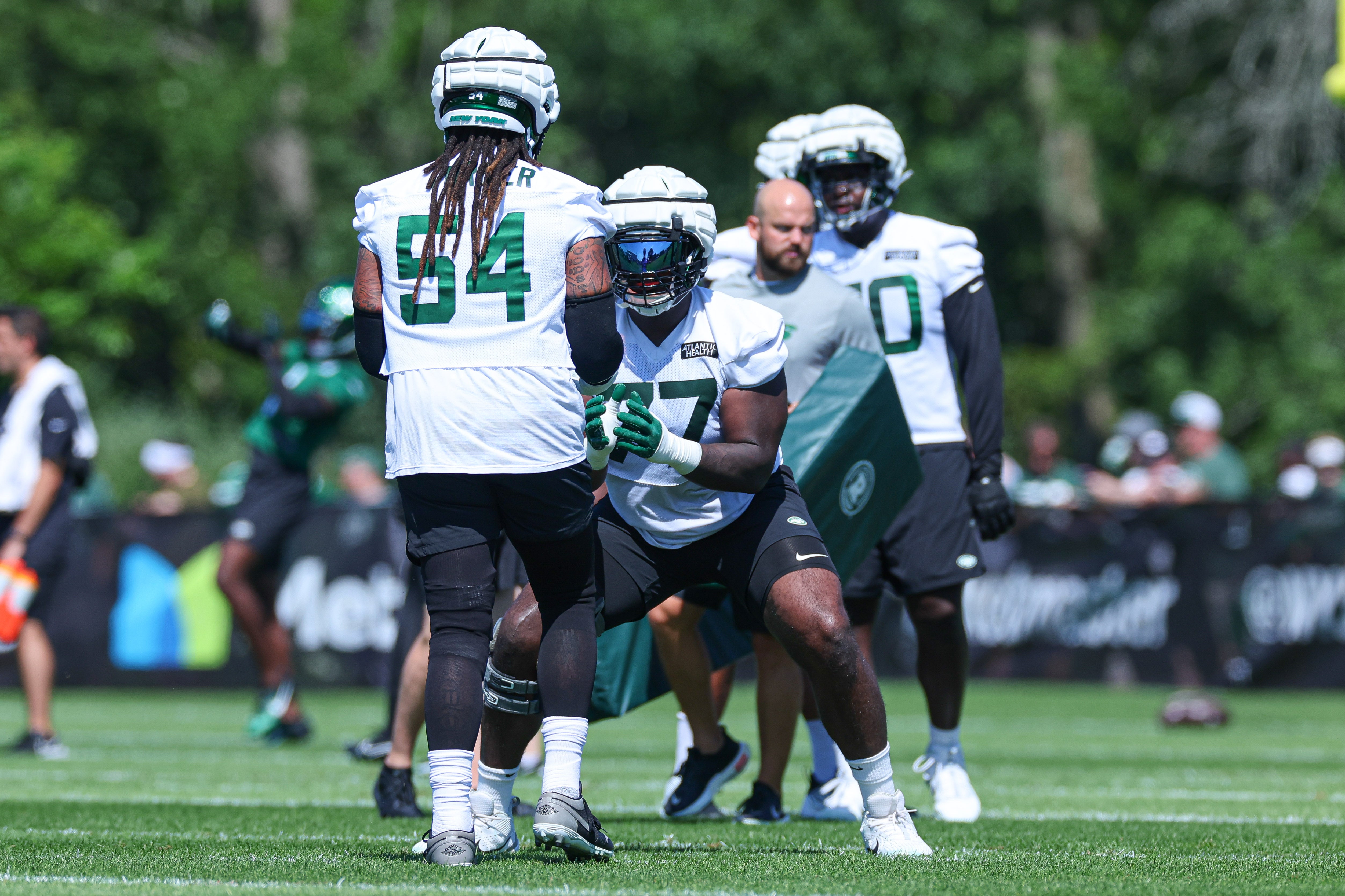 New York Jets offensive tackle Mekhi Becton (77) drills with guard Billy Turner (54) during the New York Jets Training Camp at Atlantic Health Jets Training Center.